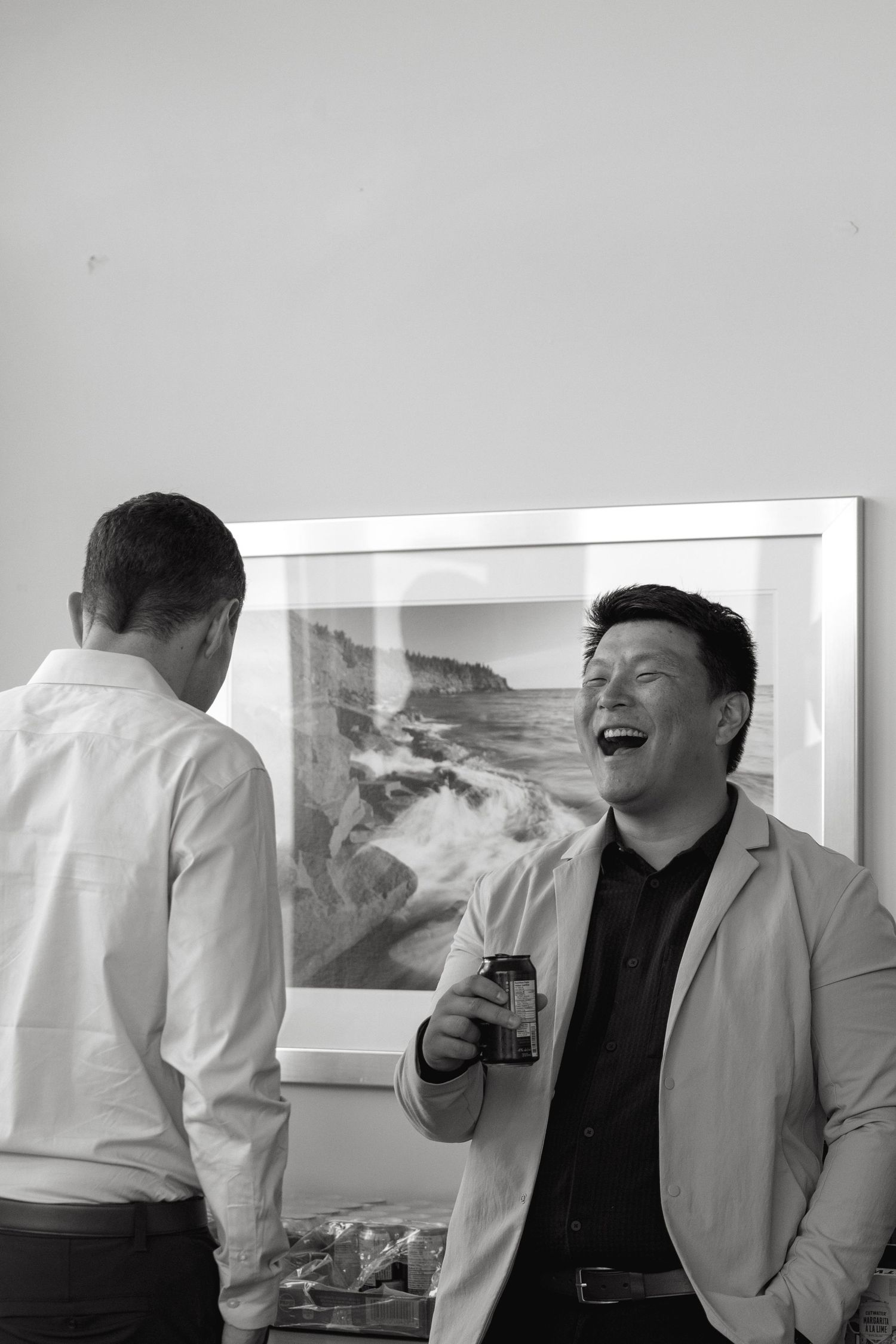 People enjoying drinks and conversation in a bright, modern indoor space.