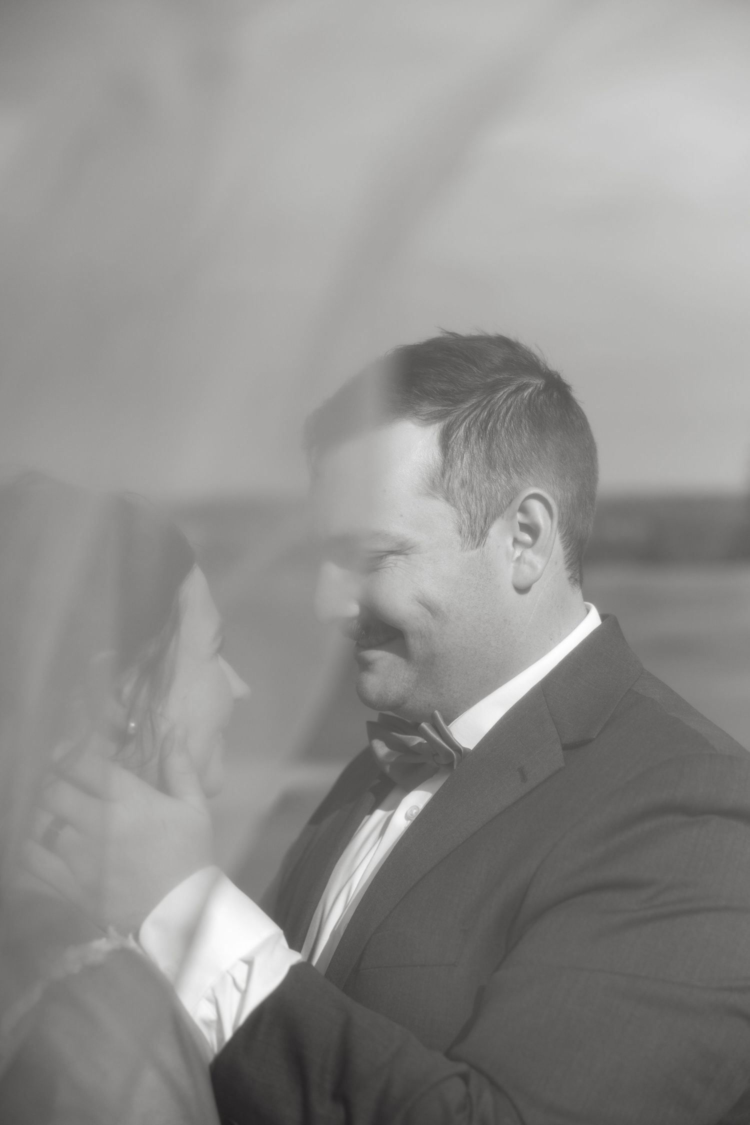 A series of black and white romantic moments captured during a wedding celebration.