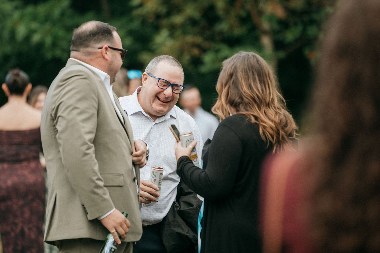 Wedding attendees share joyful moments during an outdoor celebration.