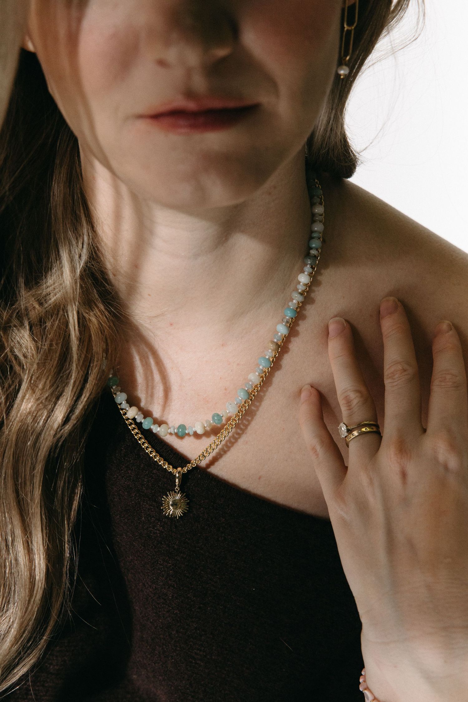 A series of jewelry photos showing turquoise beaded necklaces styled with black tops against a light background.