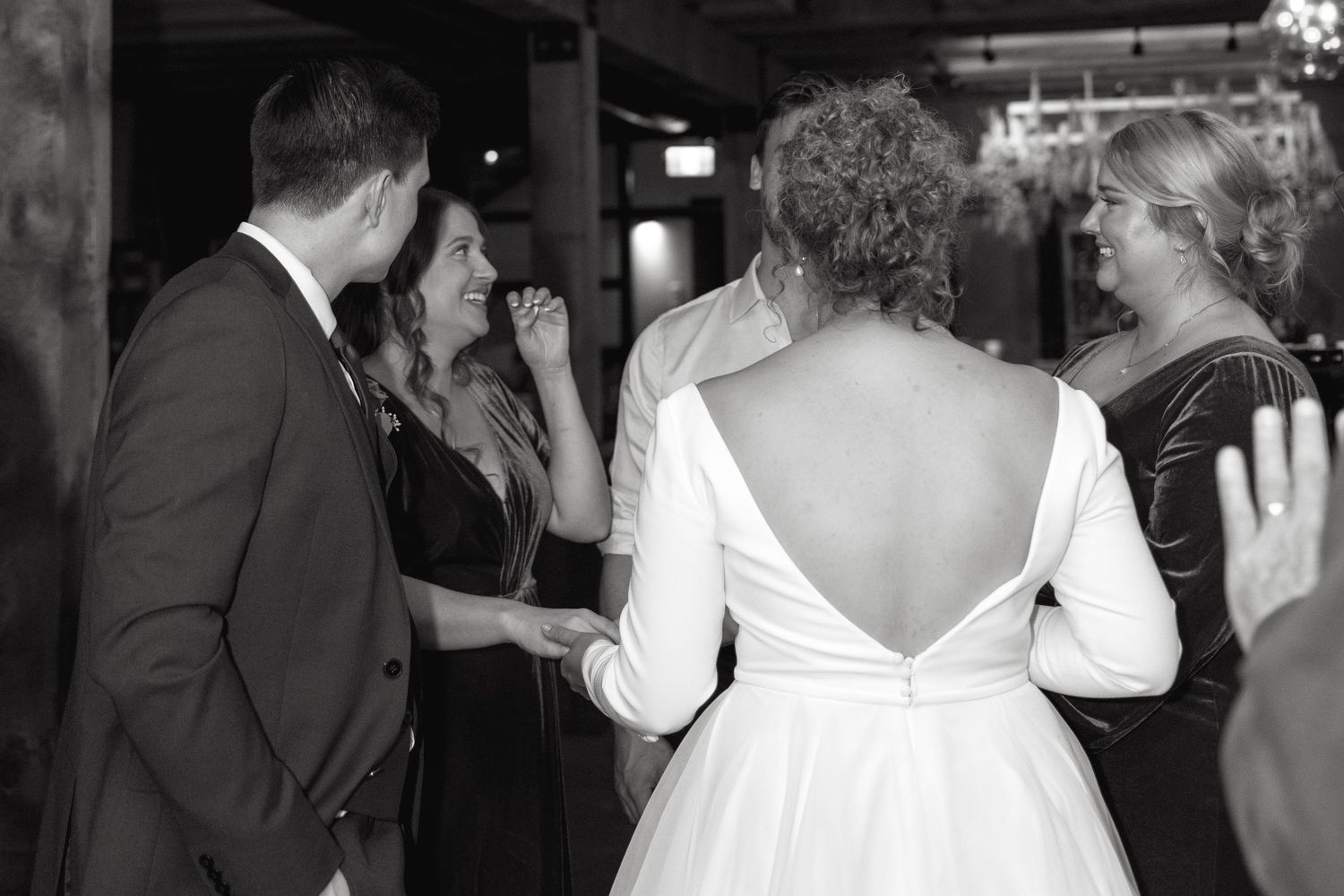 Wedding reception dance floor with guests celebrating in formal attire.
