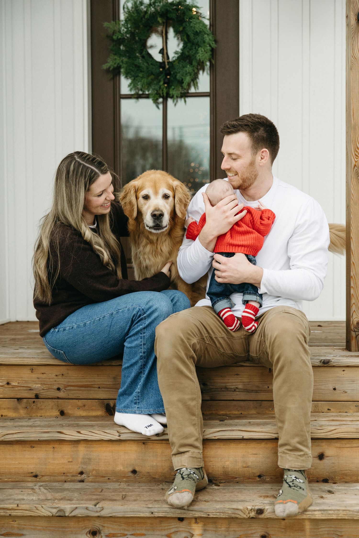 A series of candid moments captured on a wooden porch with a golden retriever and baby.
