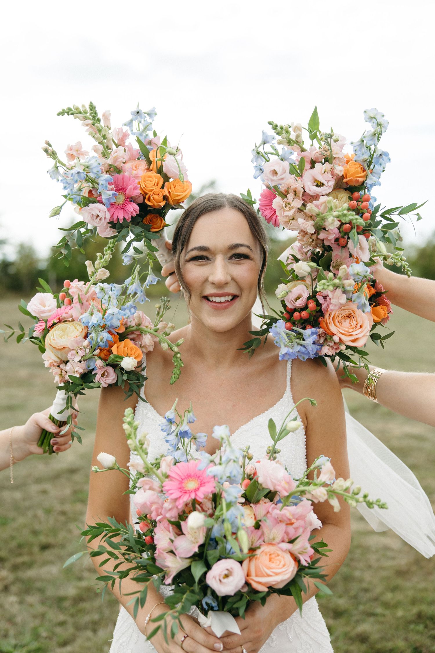 Beautiful floral wreath with pink and orange blooms frames a joyful moment.