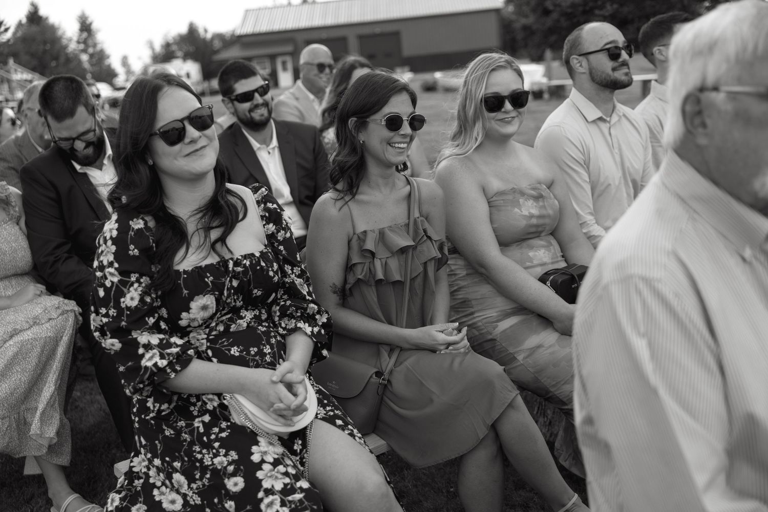 Wedding guests mingling and socializing at an outdoor reception.