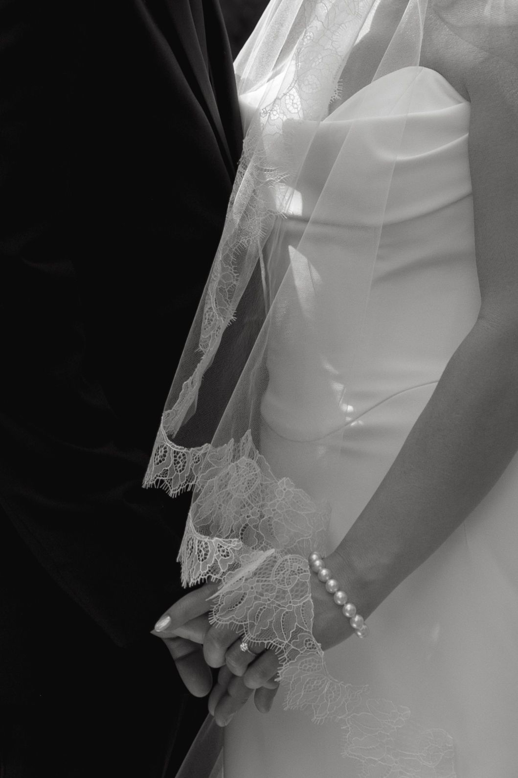 Detail shot of delicate lace and buttons on a white wedding dress.
