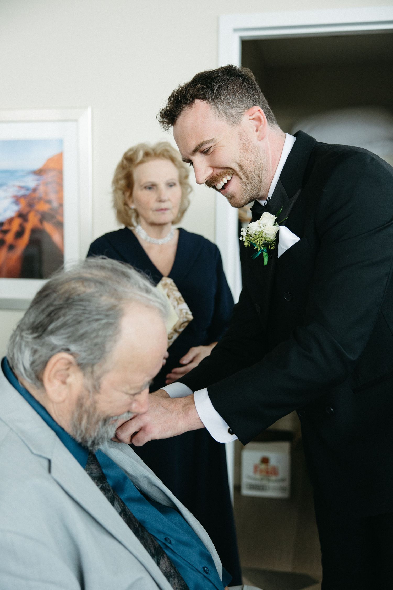 An emotional moment between family members during a formal celebration.