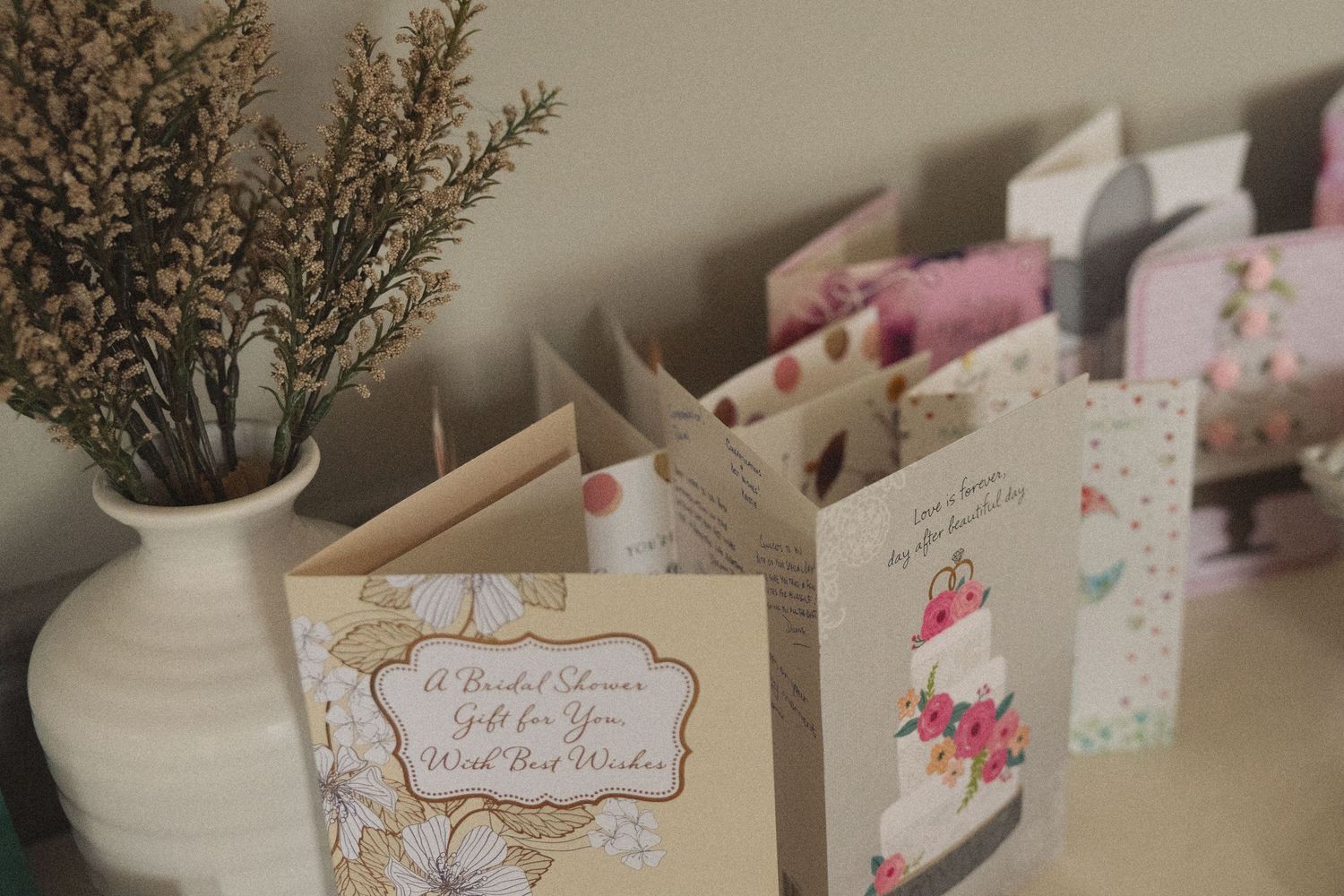 Elegant wedding place cards with floral decorations arranged on a display table.