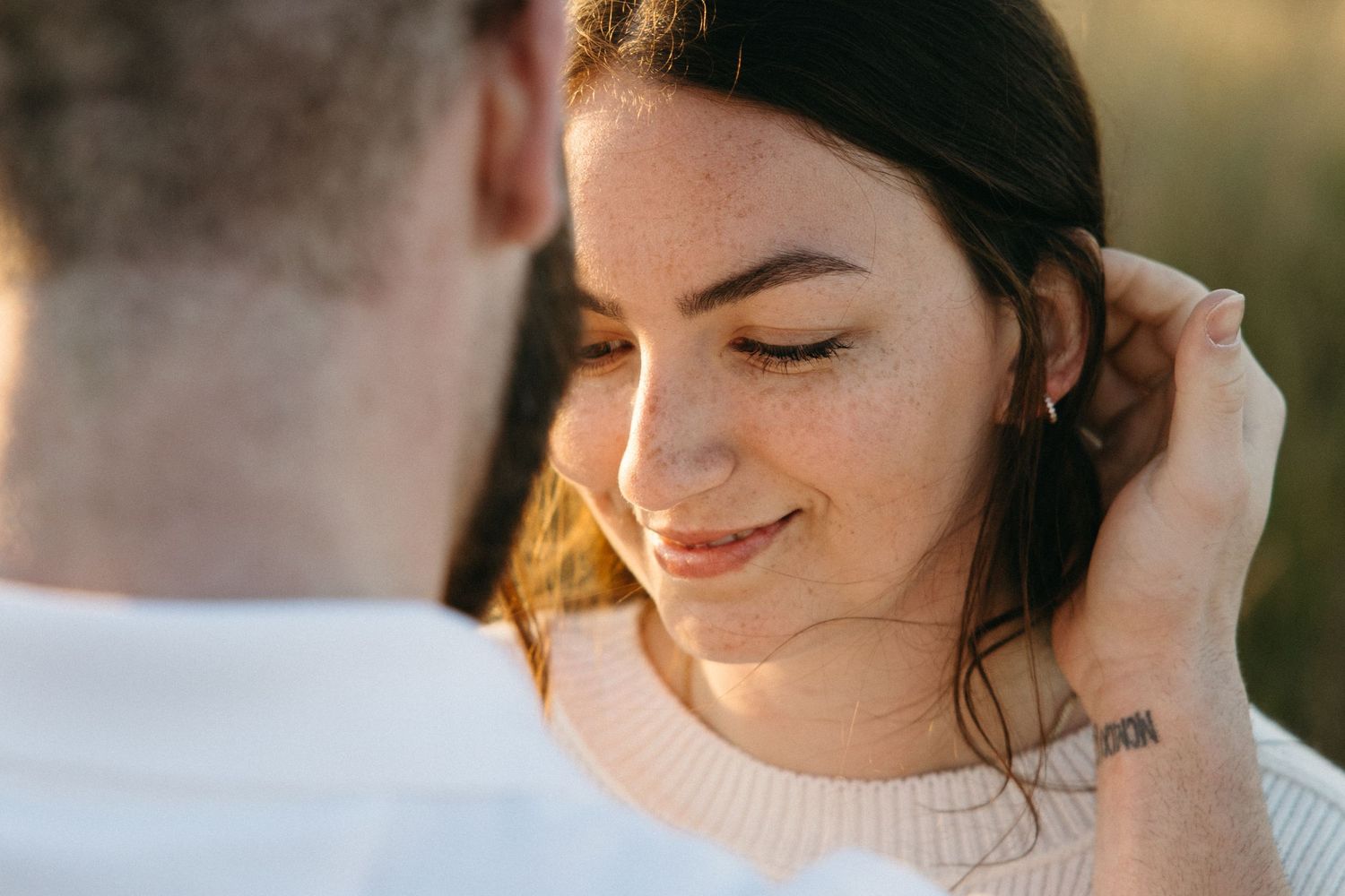 Close up portrait of person smiling during sunset outdoor photo session.