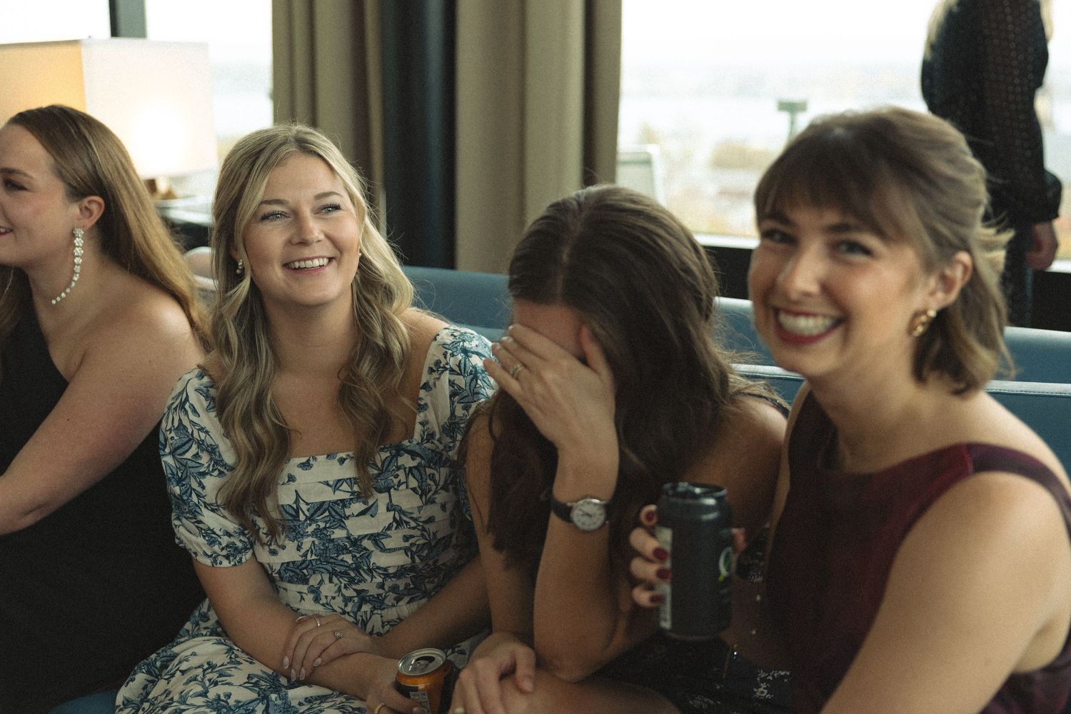 A group of elegantly dressed guests enjoying themselves at a formal celebration.