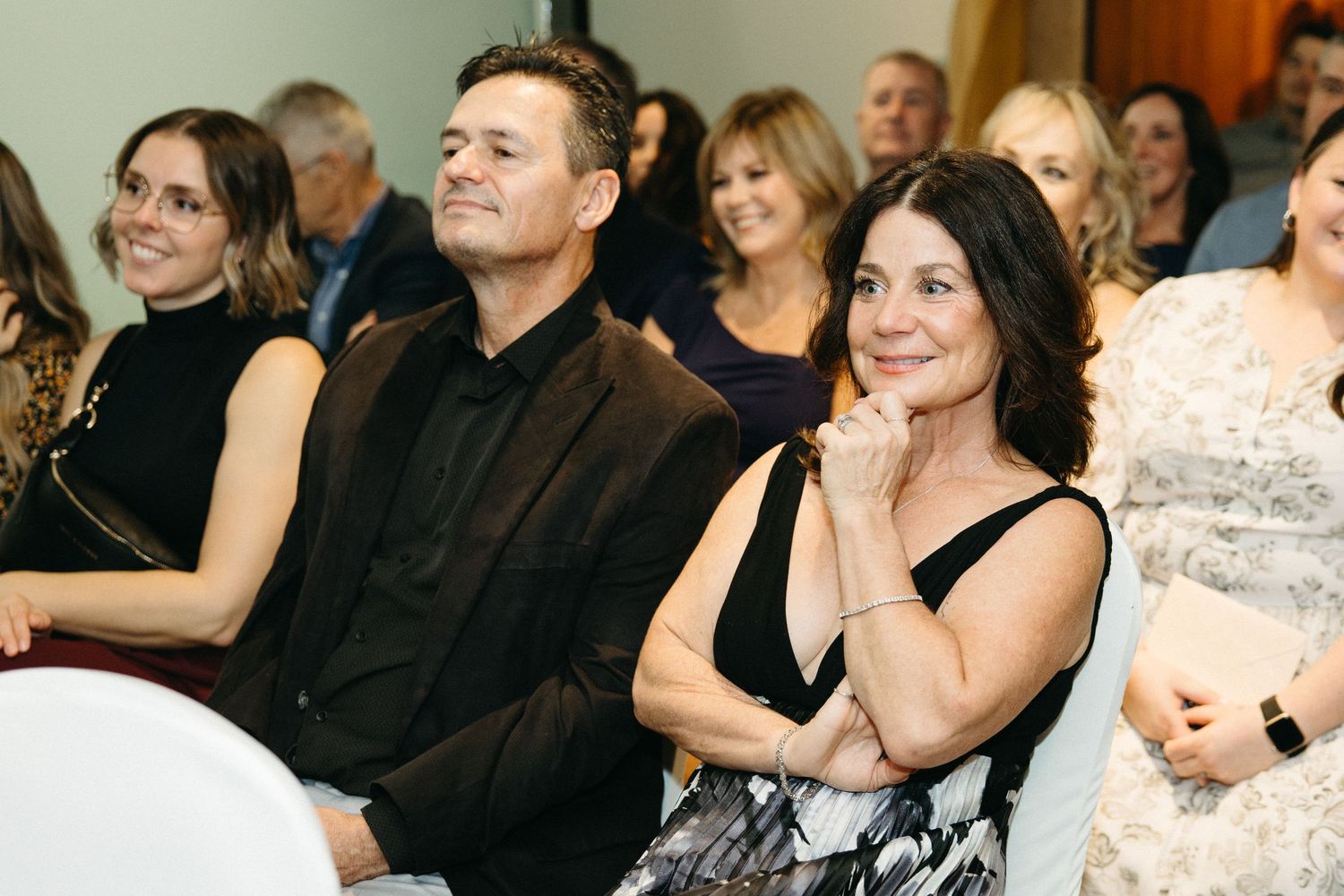 Audience members react emotionally while watching a performance or ceremony.