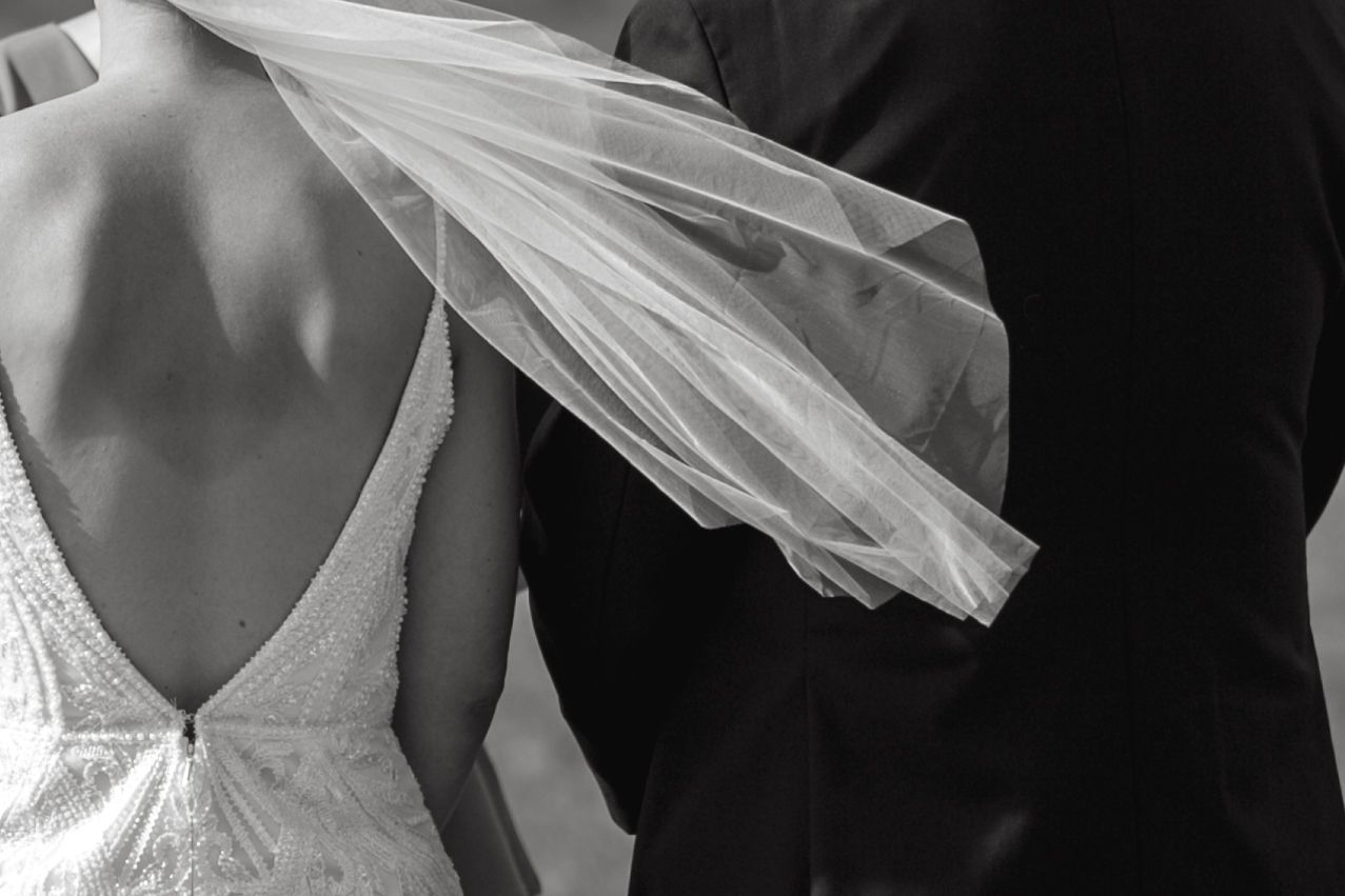 Close-up details of white lace wedding dress.