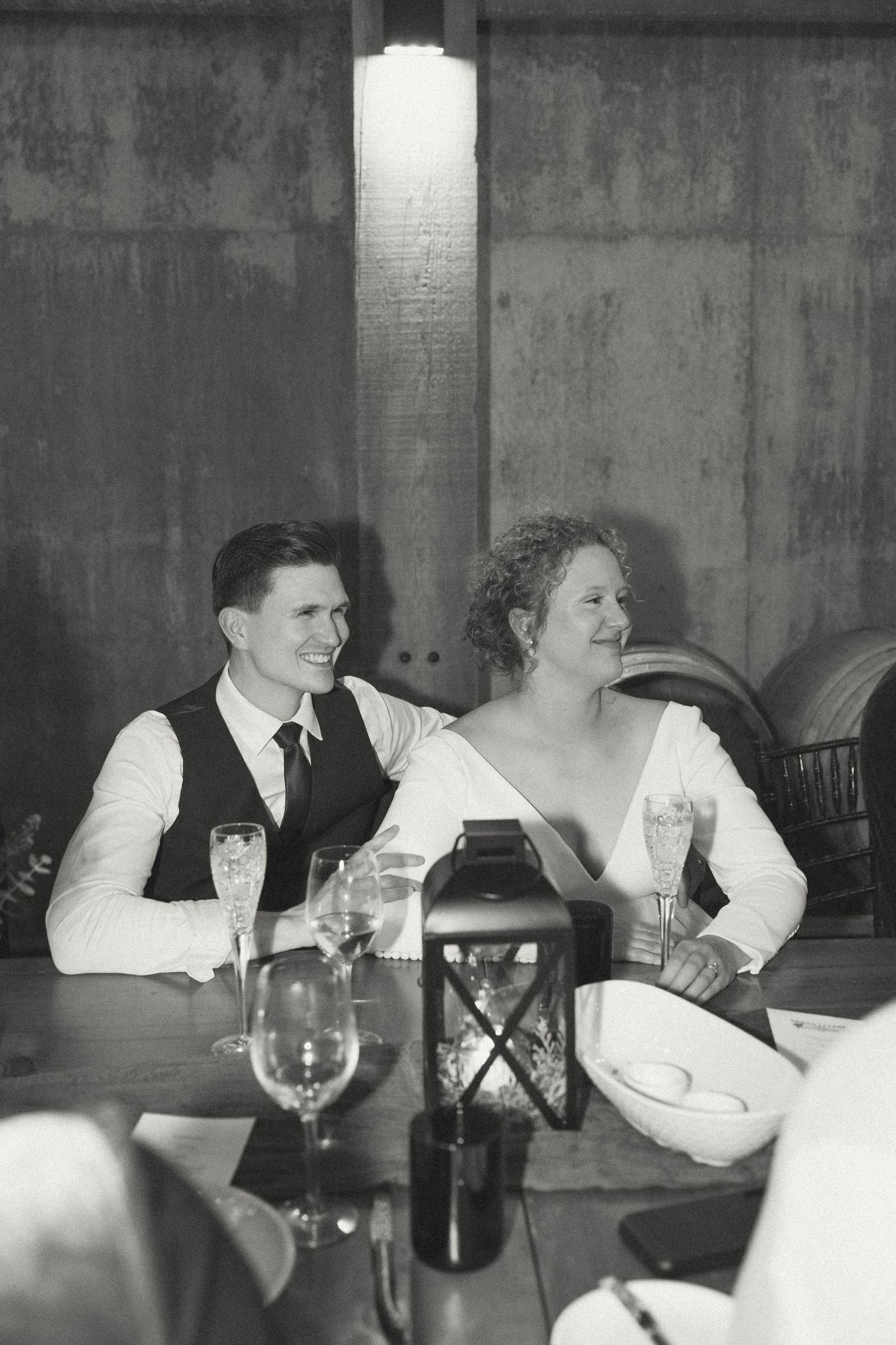 Black and white photo of guests enjoying dinner at a formal event.