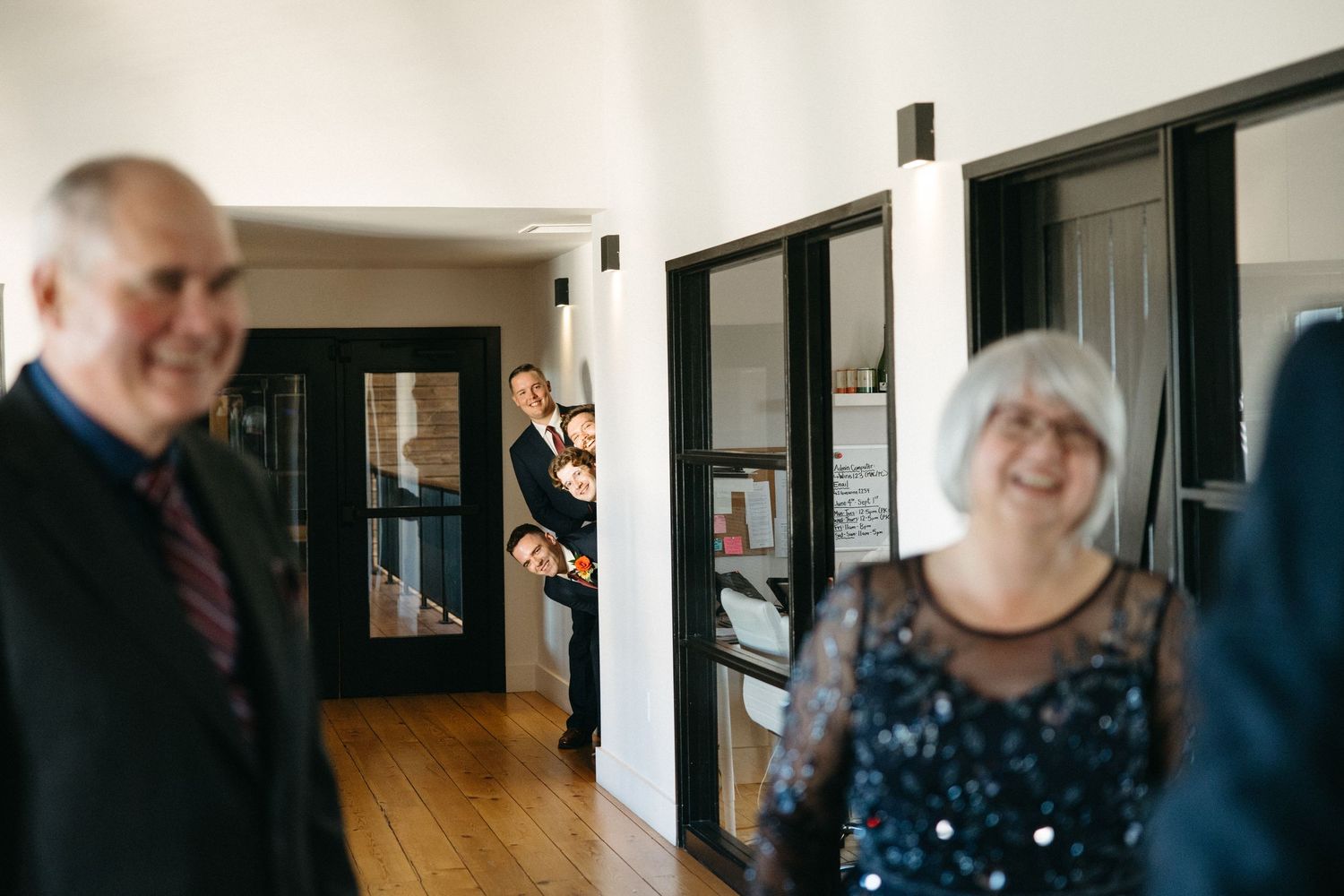 Black and white candid moments captured during wedding day preparations indoors.