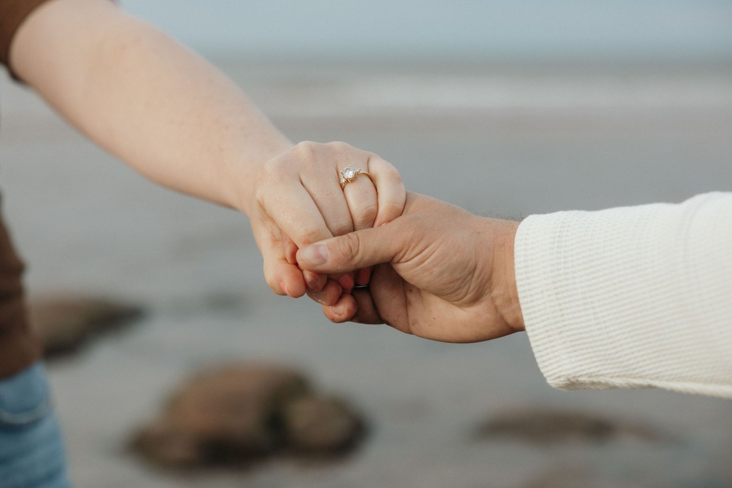 Close up view of hands exchanging wedding rings during a romantic ceremony.