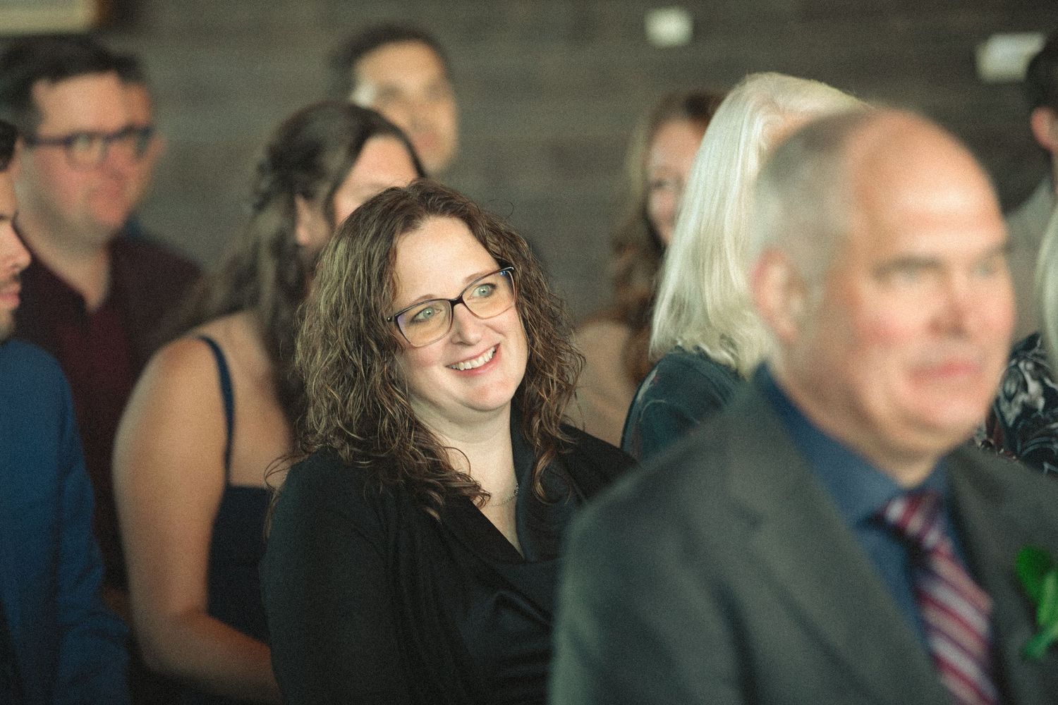 Wedding guests mingle and socialize during a reception celebration.