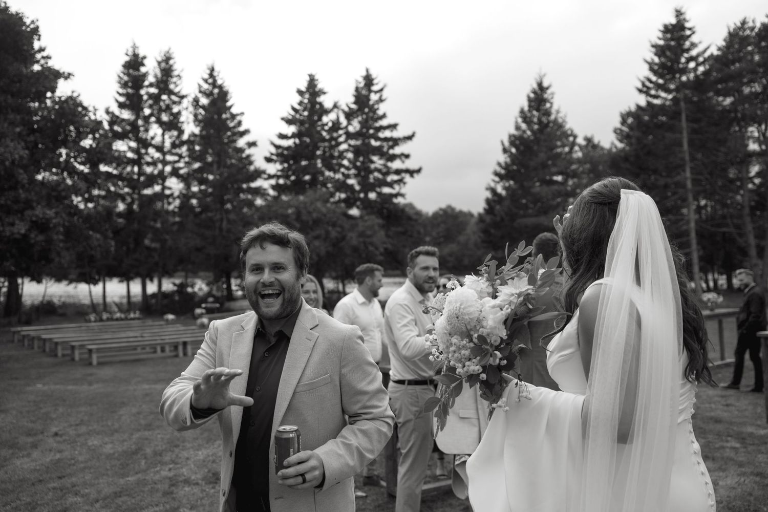 Black and white photo of joyful moments during an outdoor wedding celebration.
