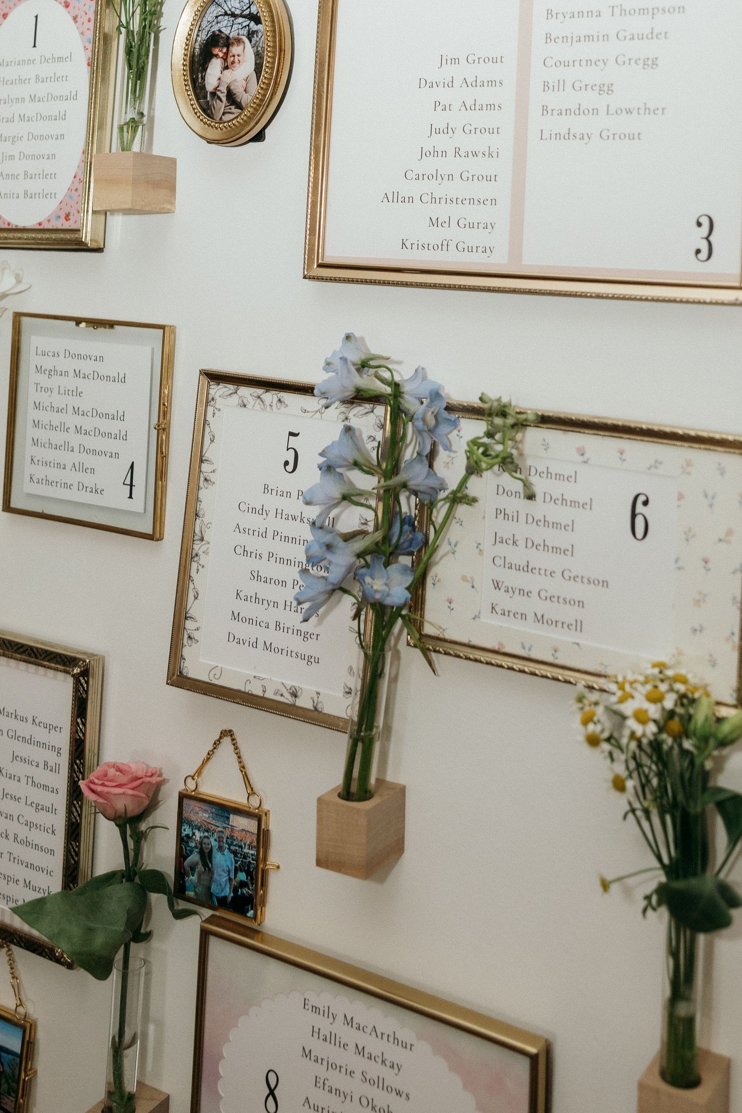 Wedding seating chart display with fresh flowers and numbered table assignments.