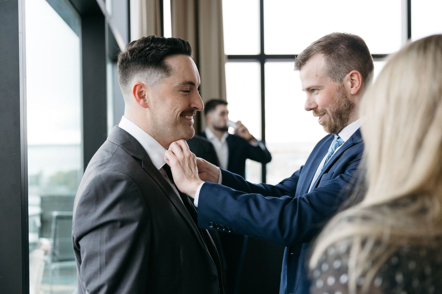 Guests sharing conversations during a formal indoor gathering.