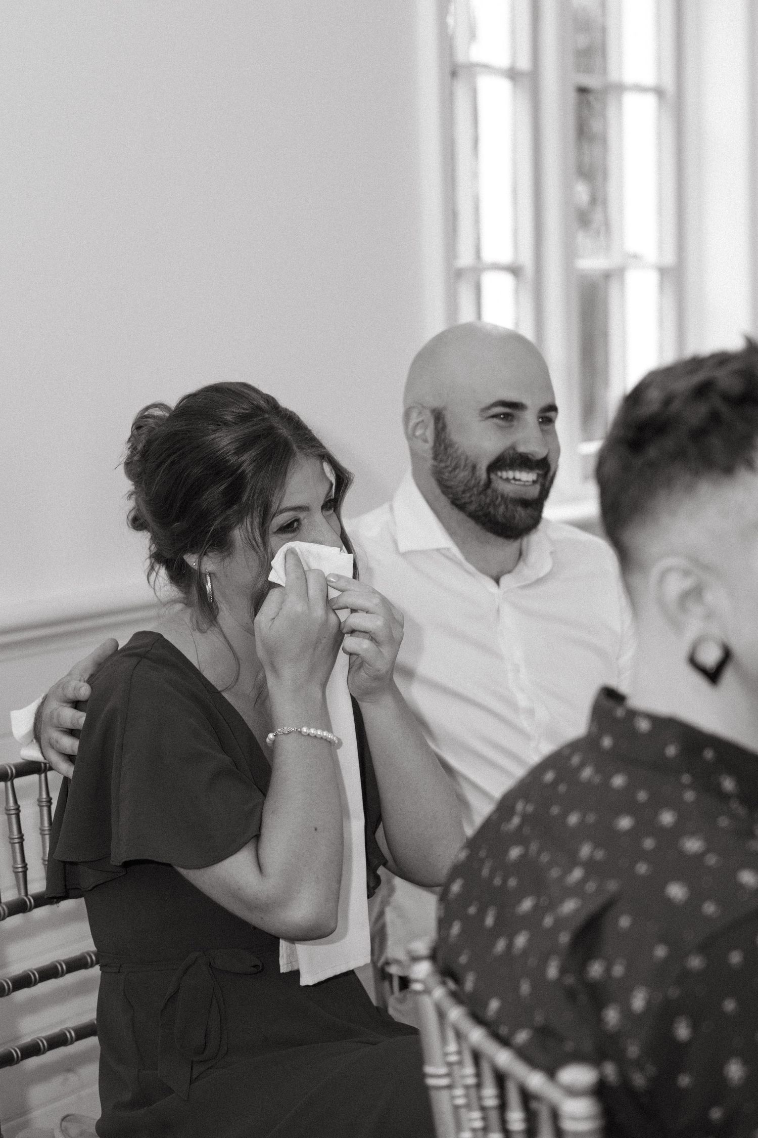 Candid black and white moments from a wedding reception.
