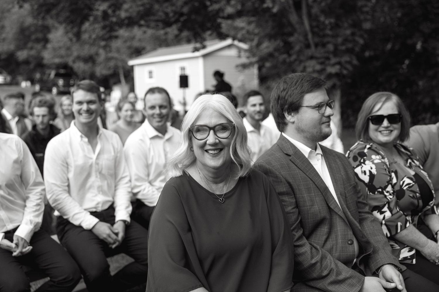 Wedding guests sharing joyful moments during an outdoor celebration.