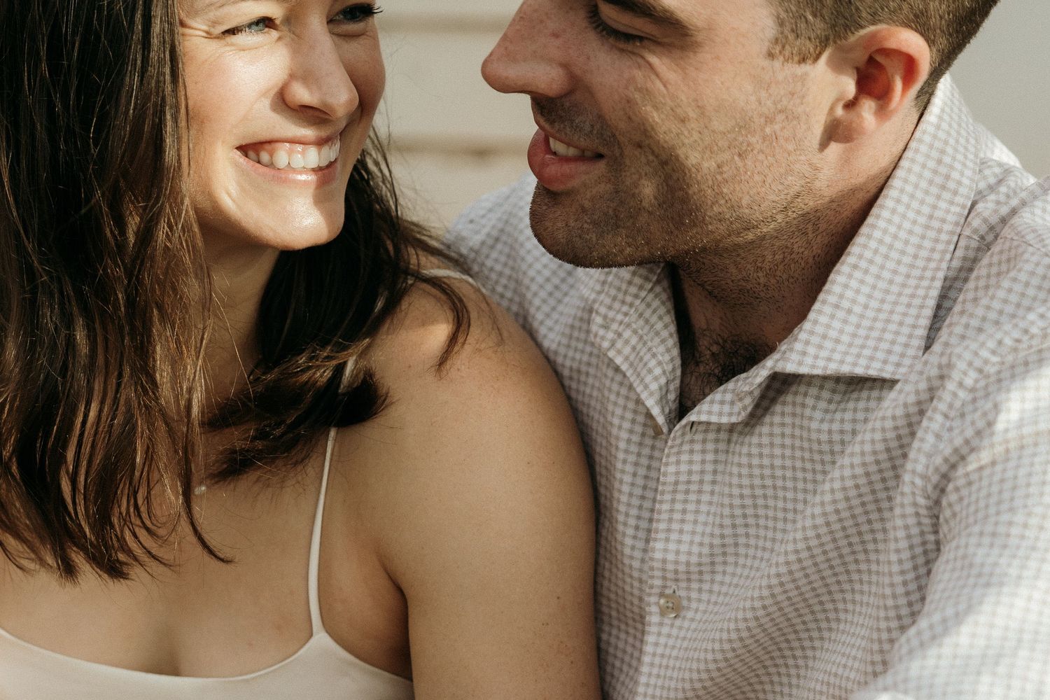 Close-up romantic portraits of a couple sharing intimate moments outdoors.