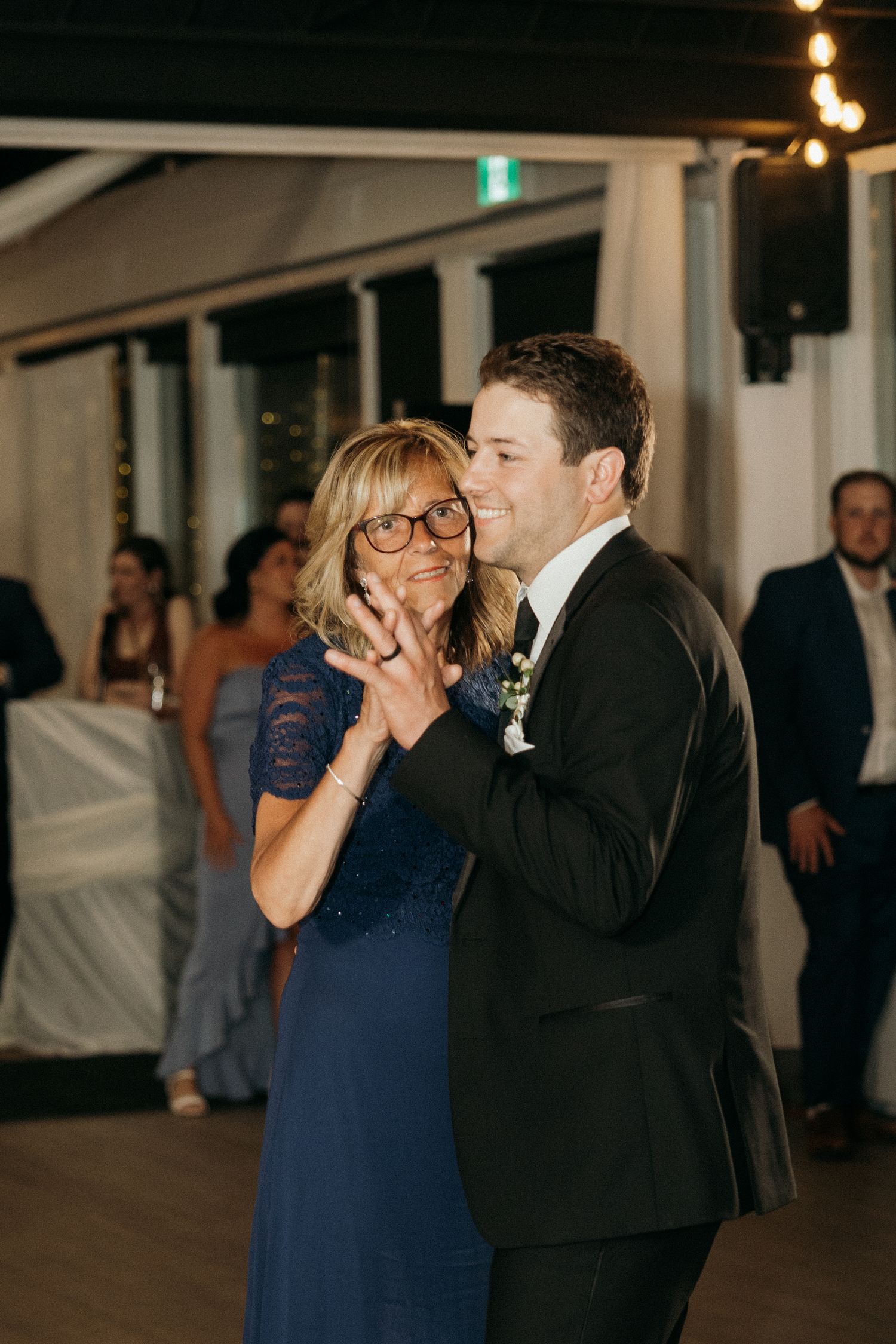 Mother-son dance moment captured during evening wedding reception.