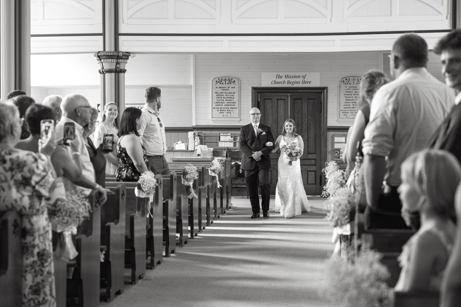 Interior of a traditional church with guests seated in pews during a ceremony.