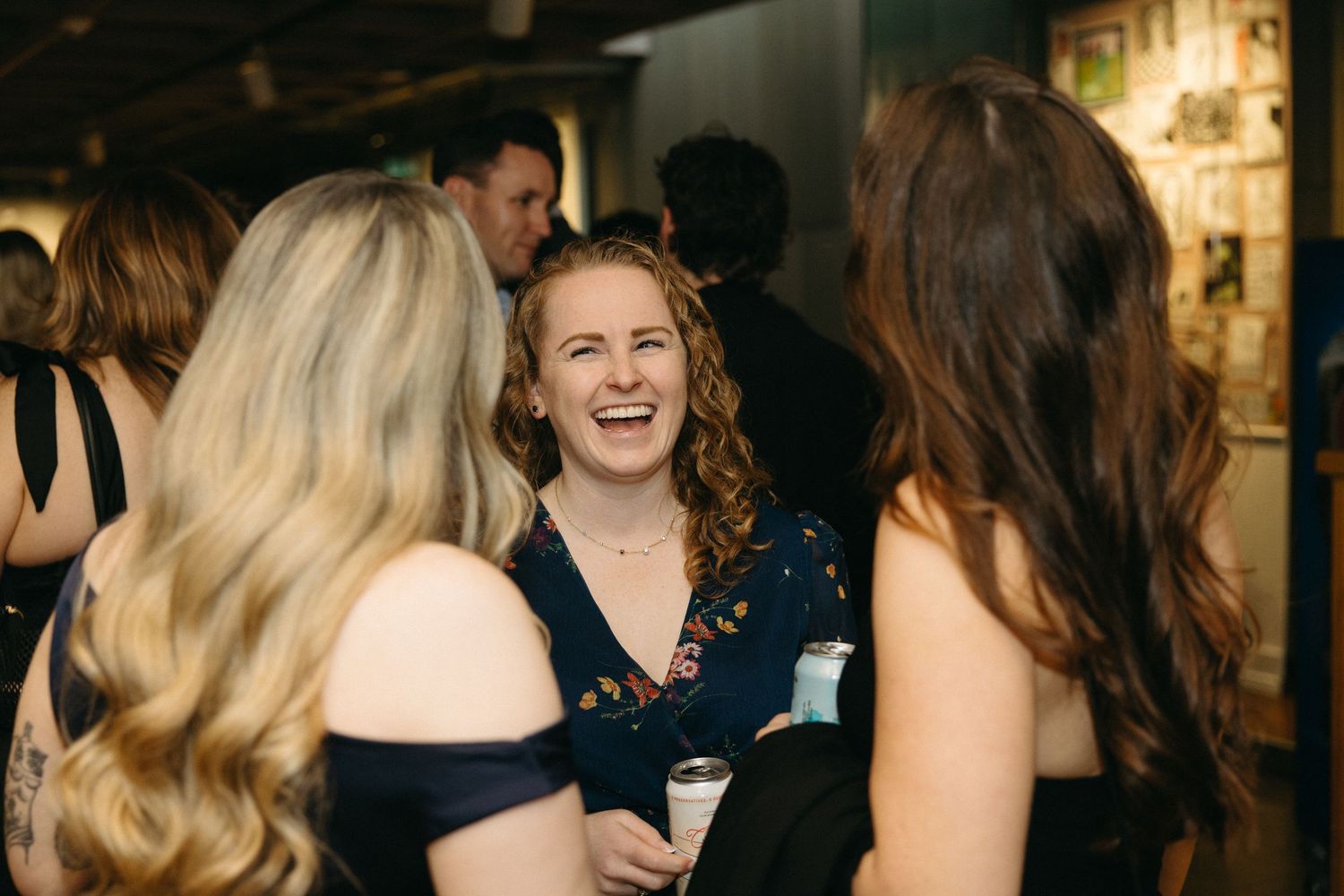 A group of people enjoying themselves at an indoor social gathering.