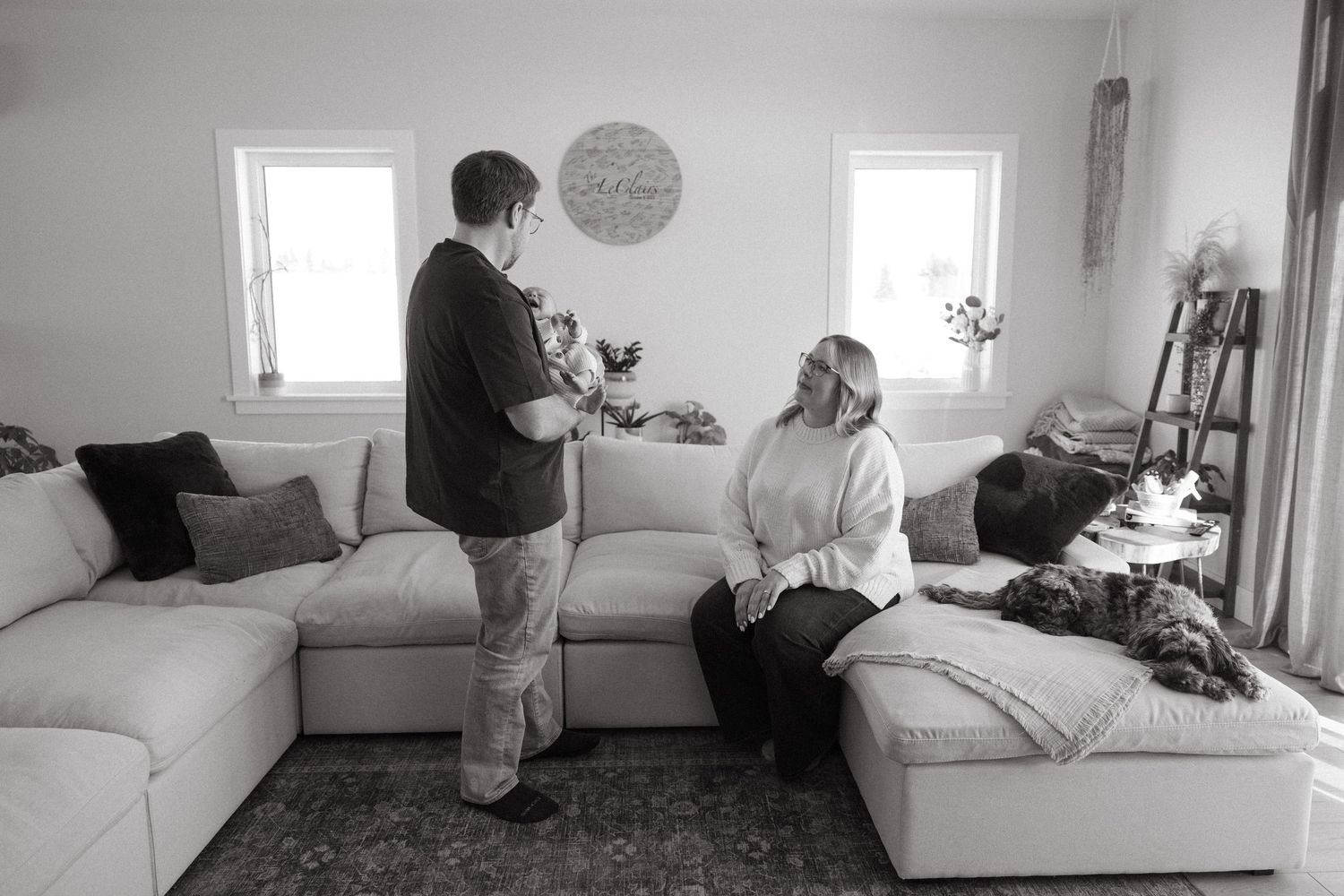 Wide angle shots showing a family spending time together in a bright, minimalist living room.
