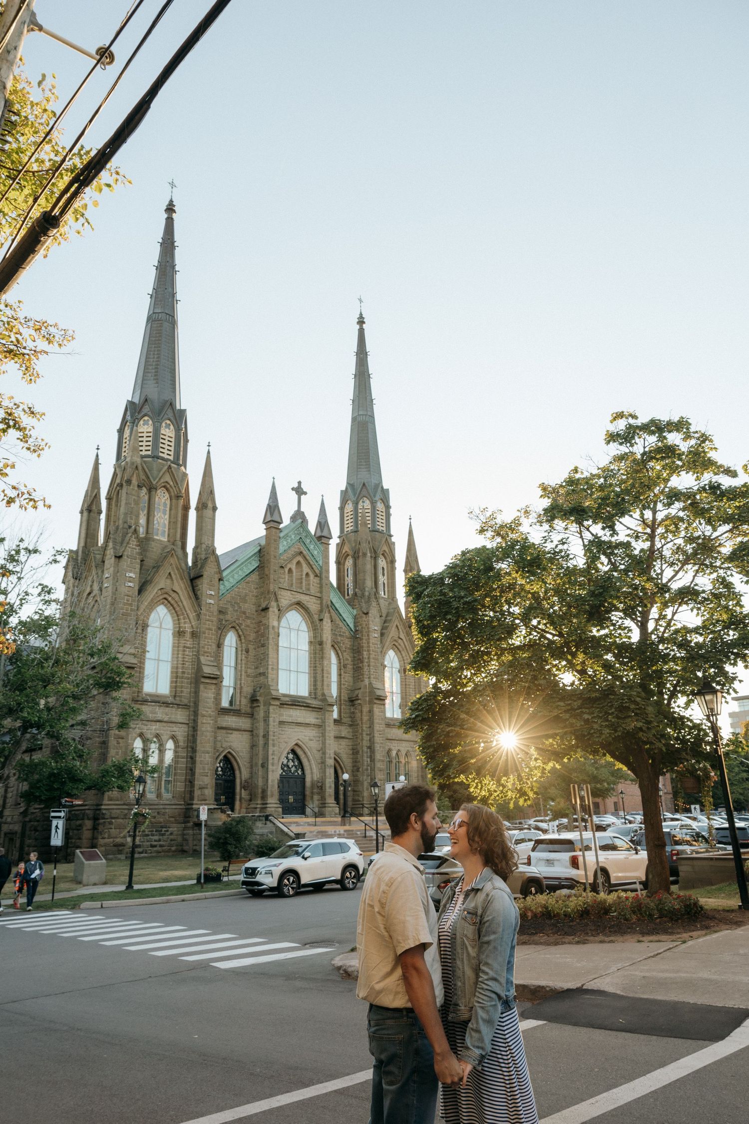 Gothic church with ornate spires provides backdrop for romantic evening scene.