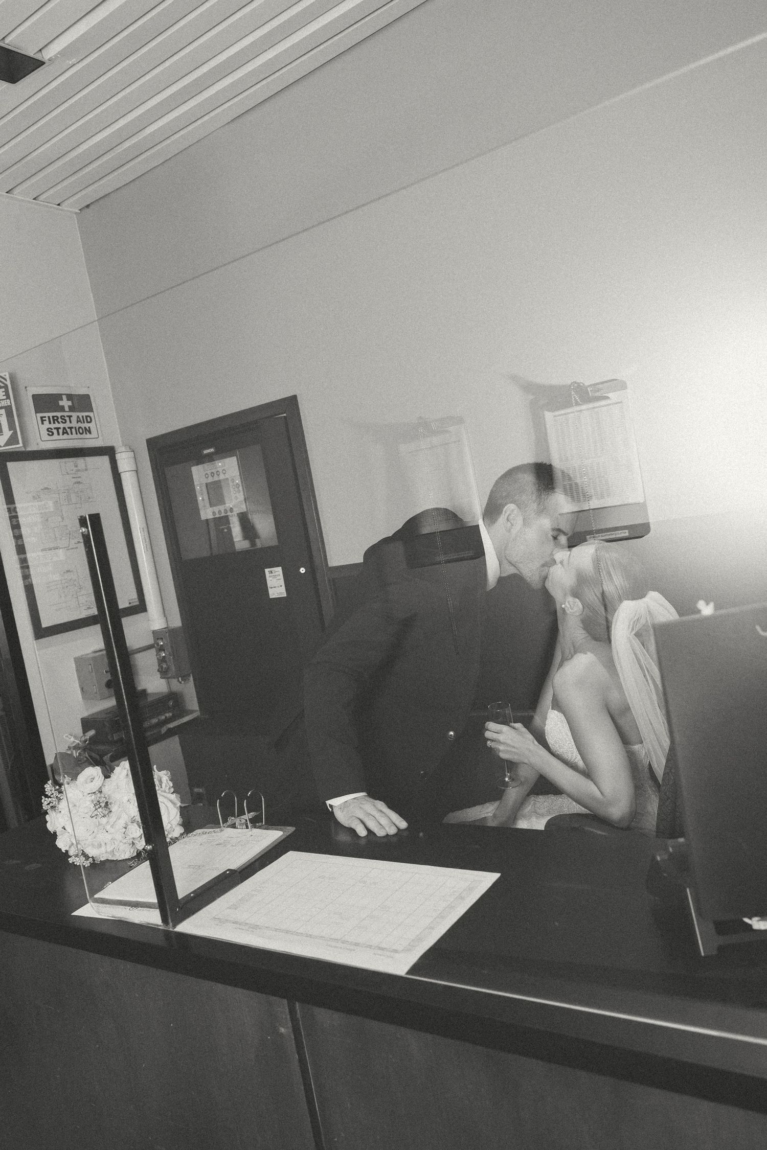 Black and white candid shots of wedding preparations in an office setting.
