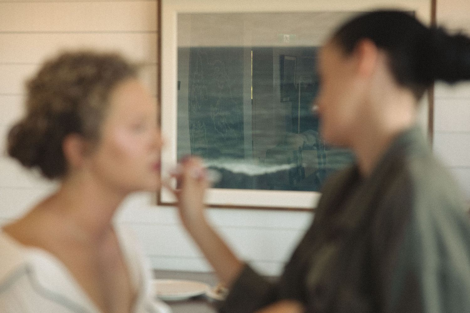 Blurred image of wedding preparation with makeup application.