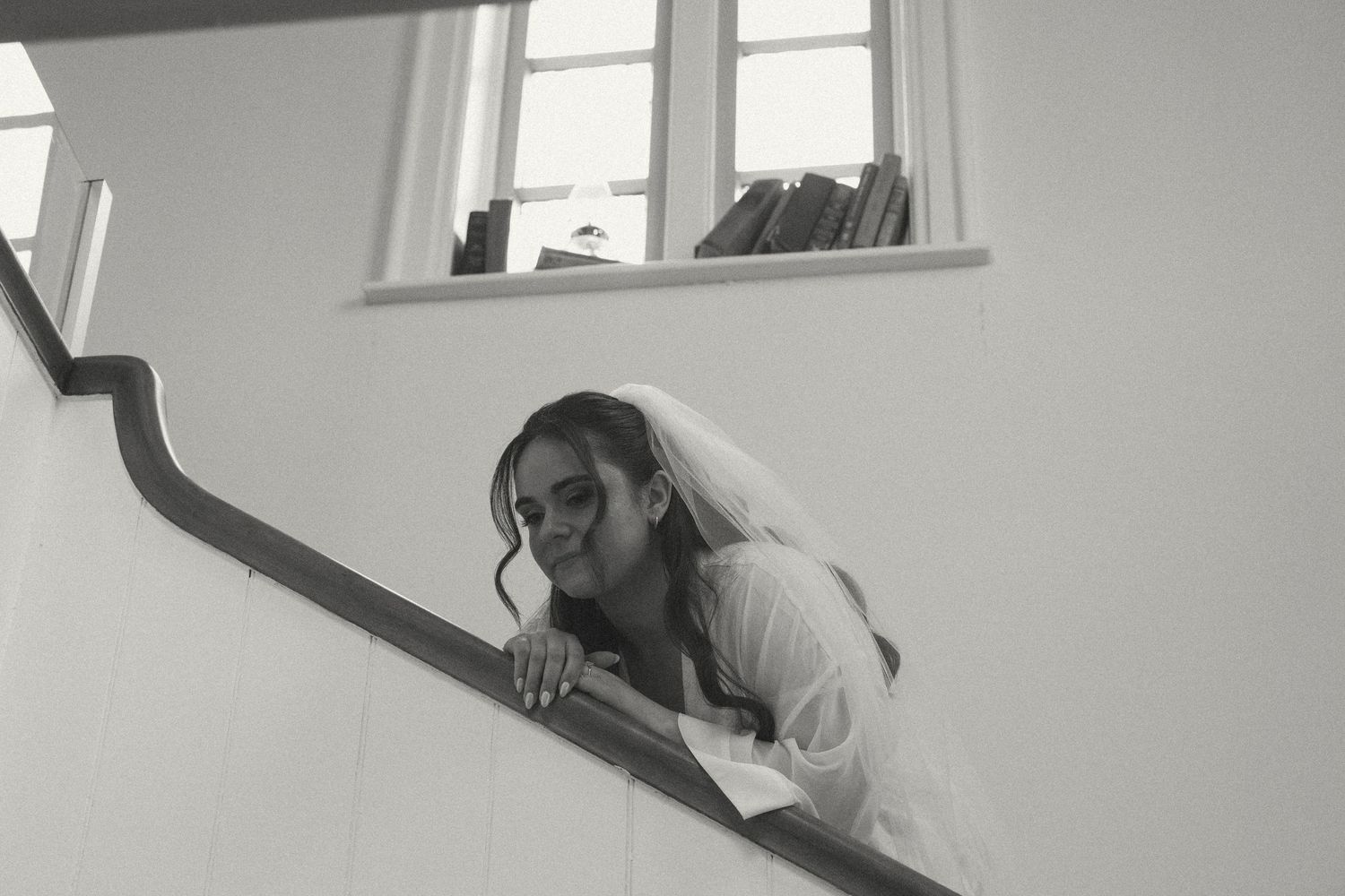 Black and white photo of getting ready moments in a bright room.