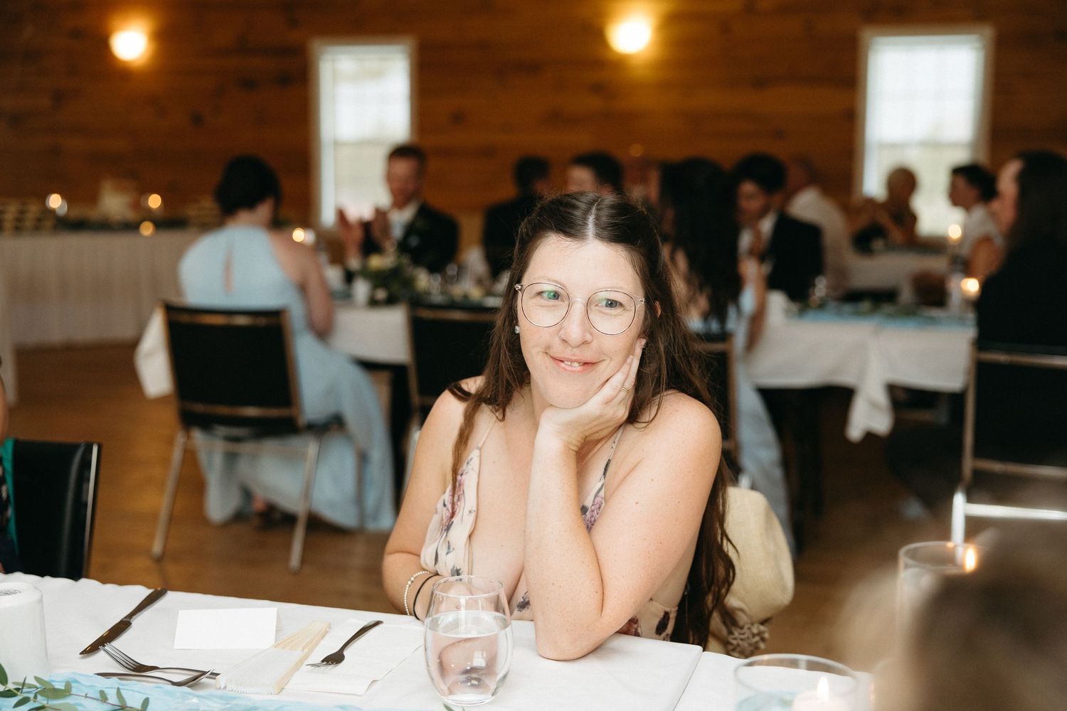 Reception venue with warm lighting and rustic wooden walls.