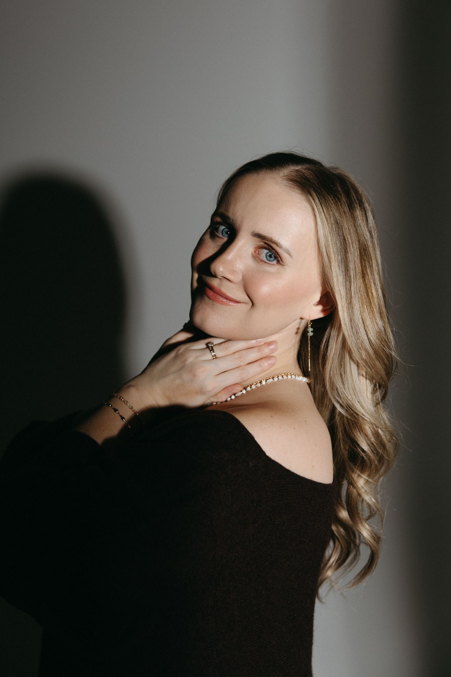 Artistic portrait series in dramatic lighting showing expressive poses against a dark background.