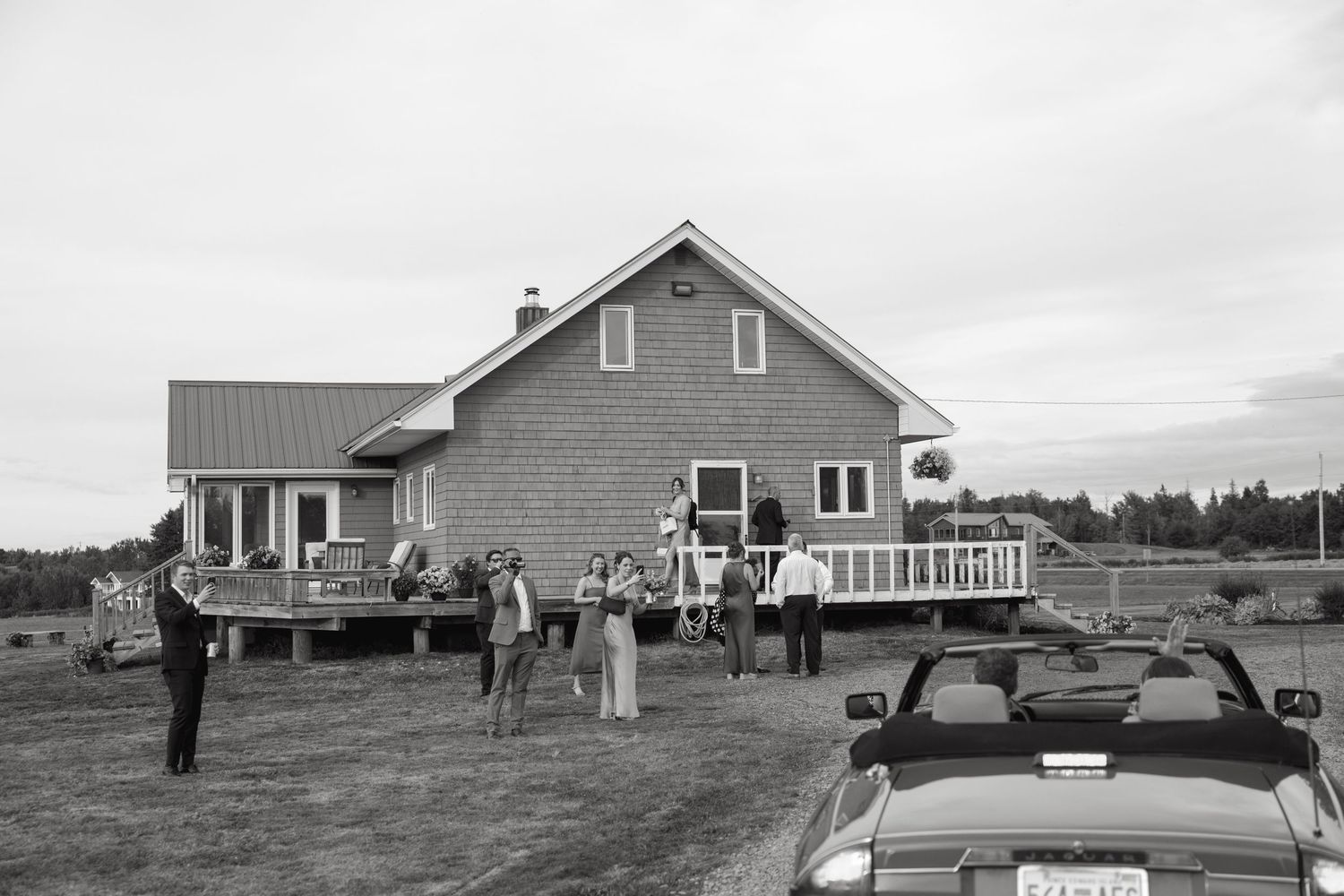 Rural farmhouse wedding venue with rustic buildings and open fields.