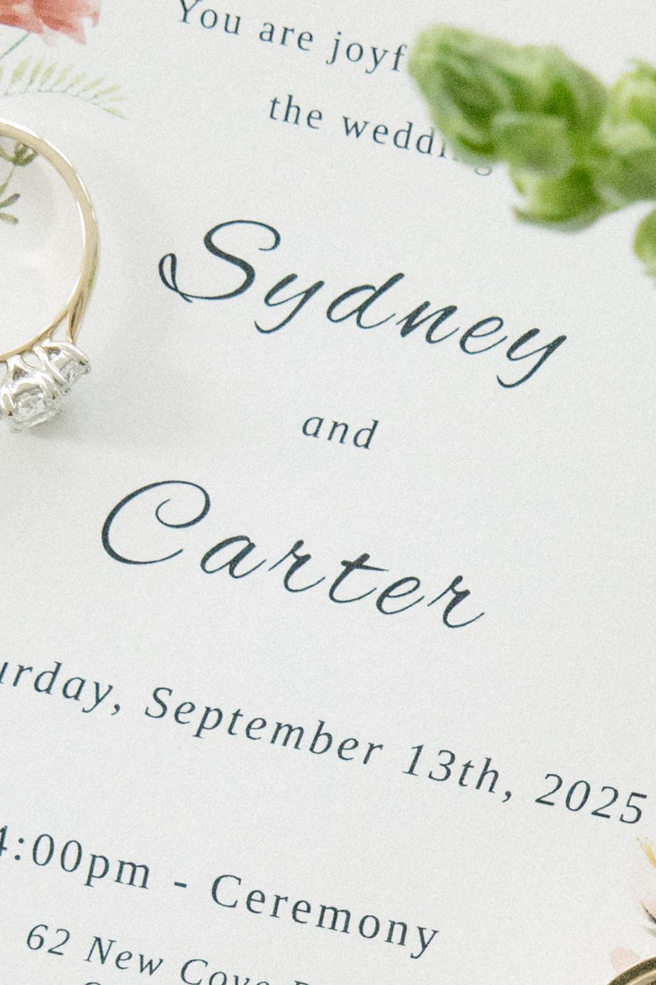 Close-up of wedding invitation text with elegant calligraphy and floral details.