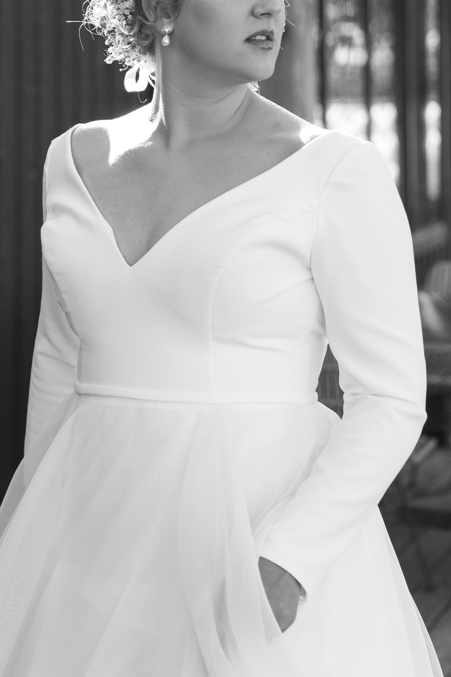 Elegant bridal portraits highlighting a classic white wedding dress with structured details.