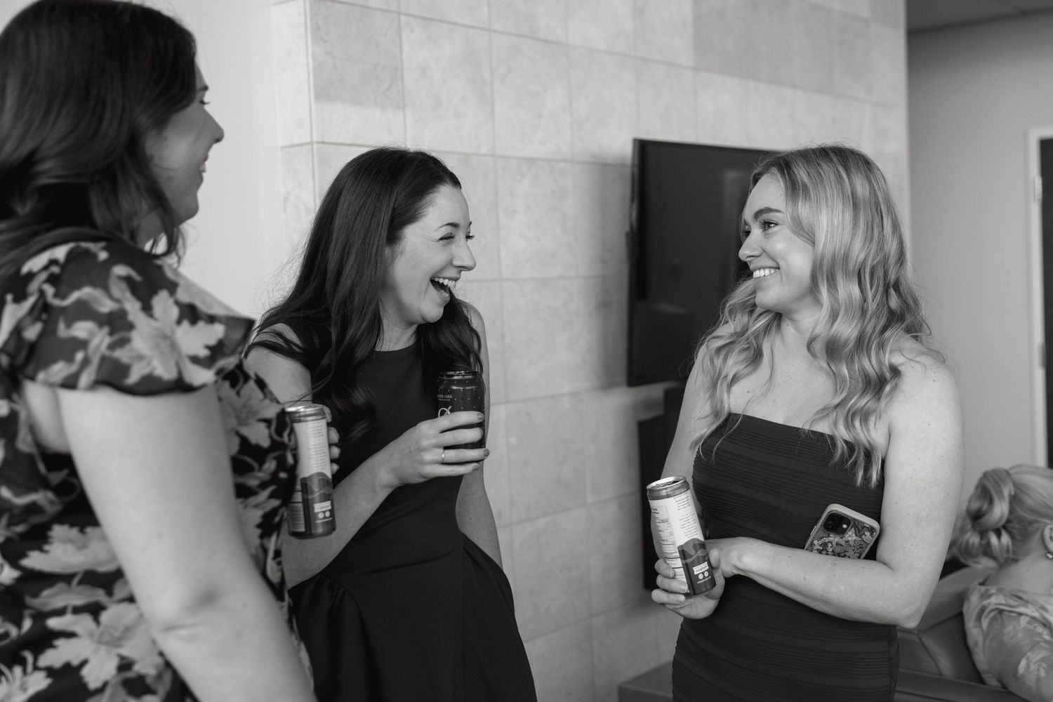 Black and white candid shots of guests enjoying themselves at an elegant party.