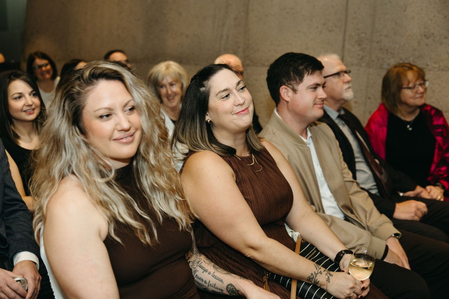 Crowd of attendees watching intently during an indoor gathering.