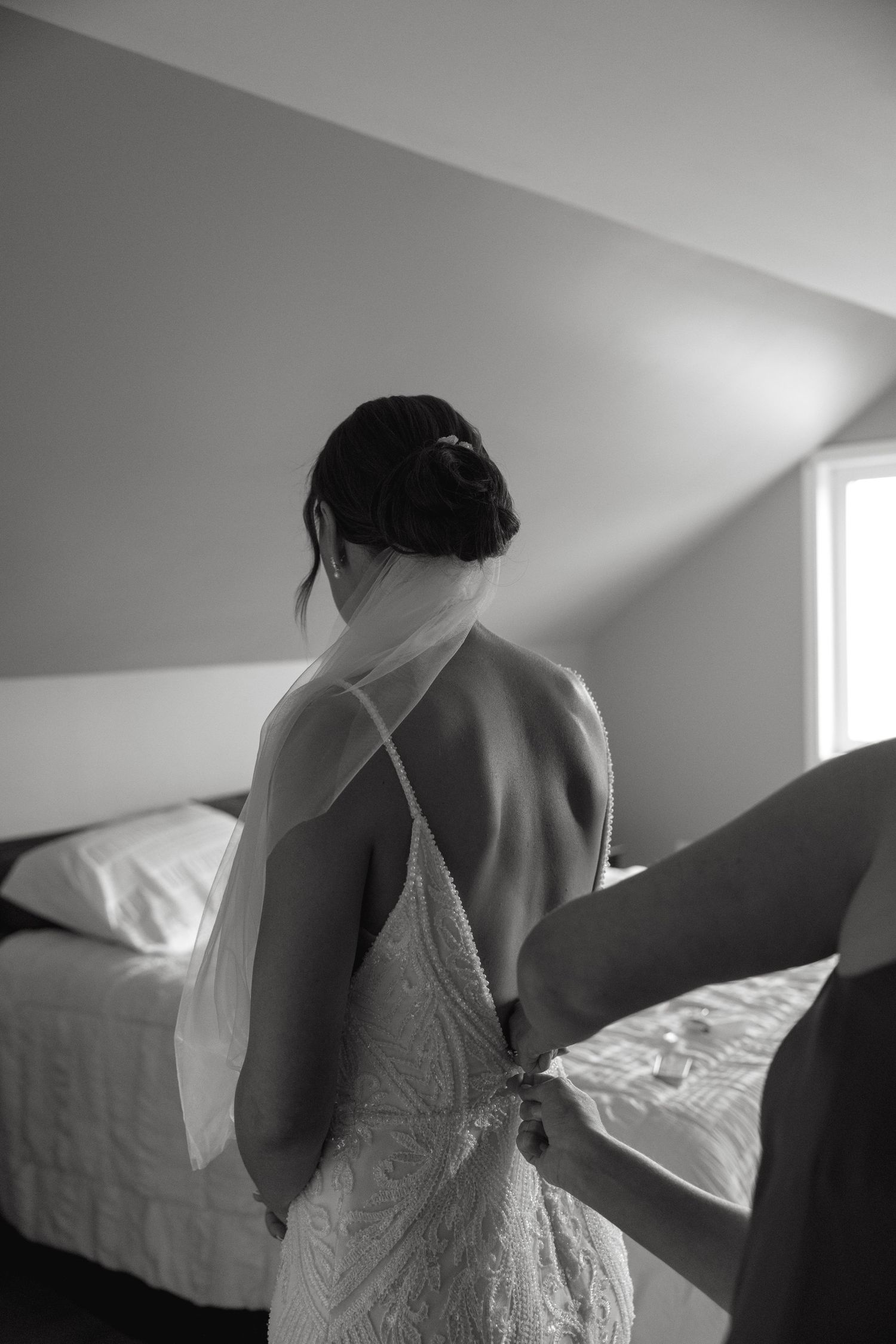 Artistic black and white photography of bridal preparation in morning light.