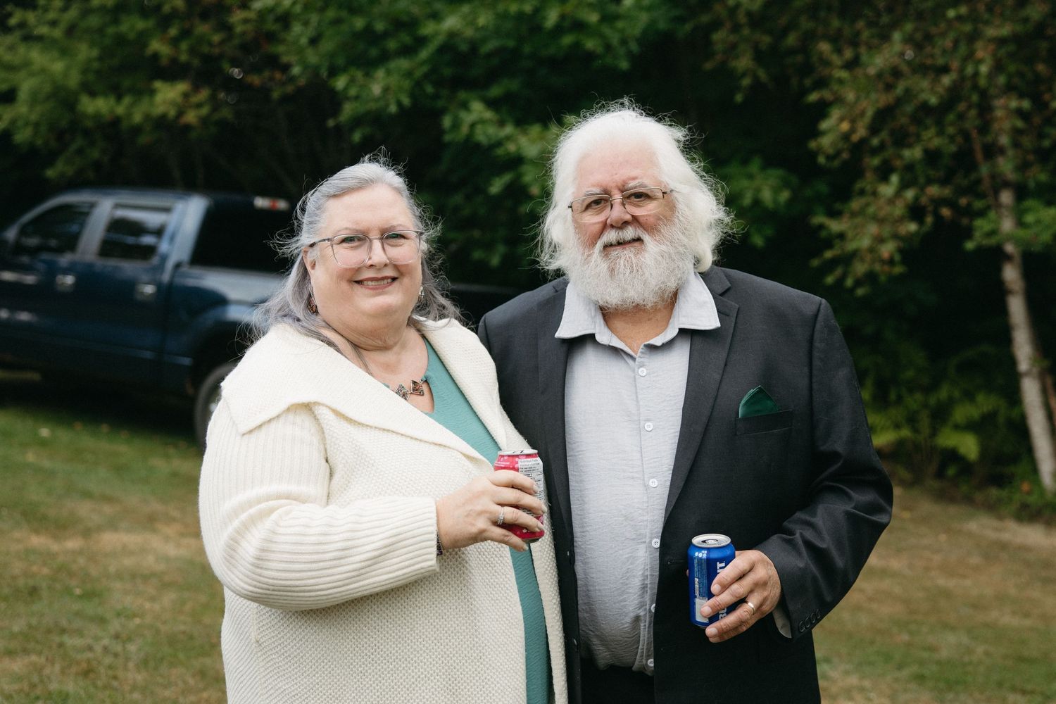 Wedding guests enjoying drinks and conversation during an outdoor reception.