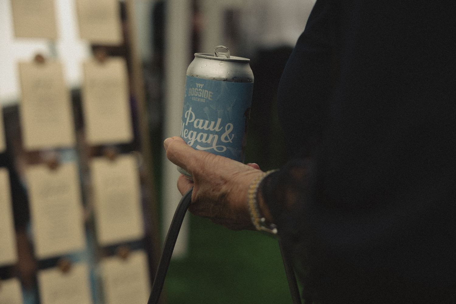 Wedding celebration with craft beer cans being shared.