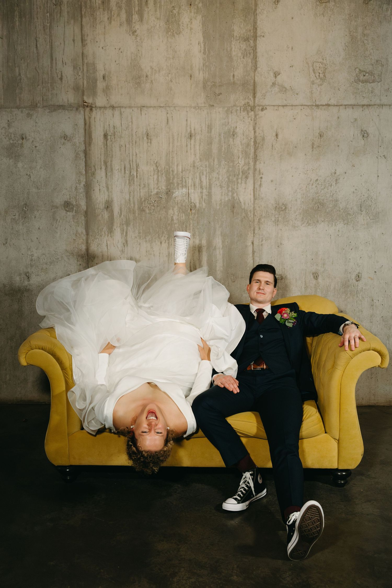 Newlyweds relax and laugh together on a yellow sofa in an artistic photo sequence.
