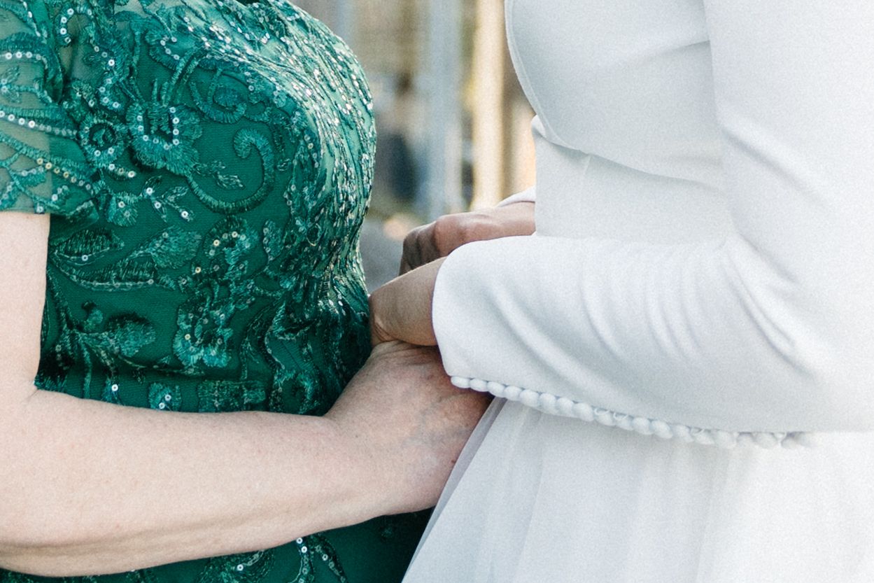 Close-up detail of white and emerald green formal attire fabric.