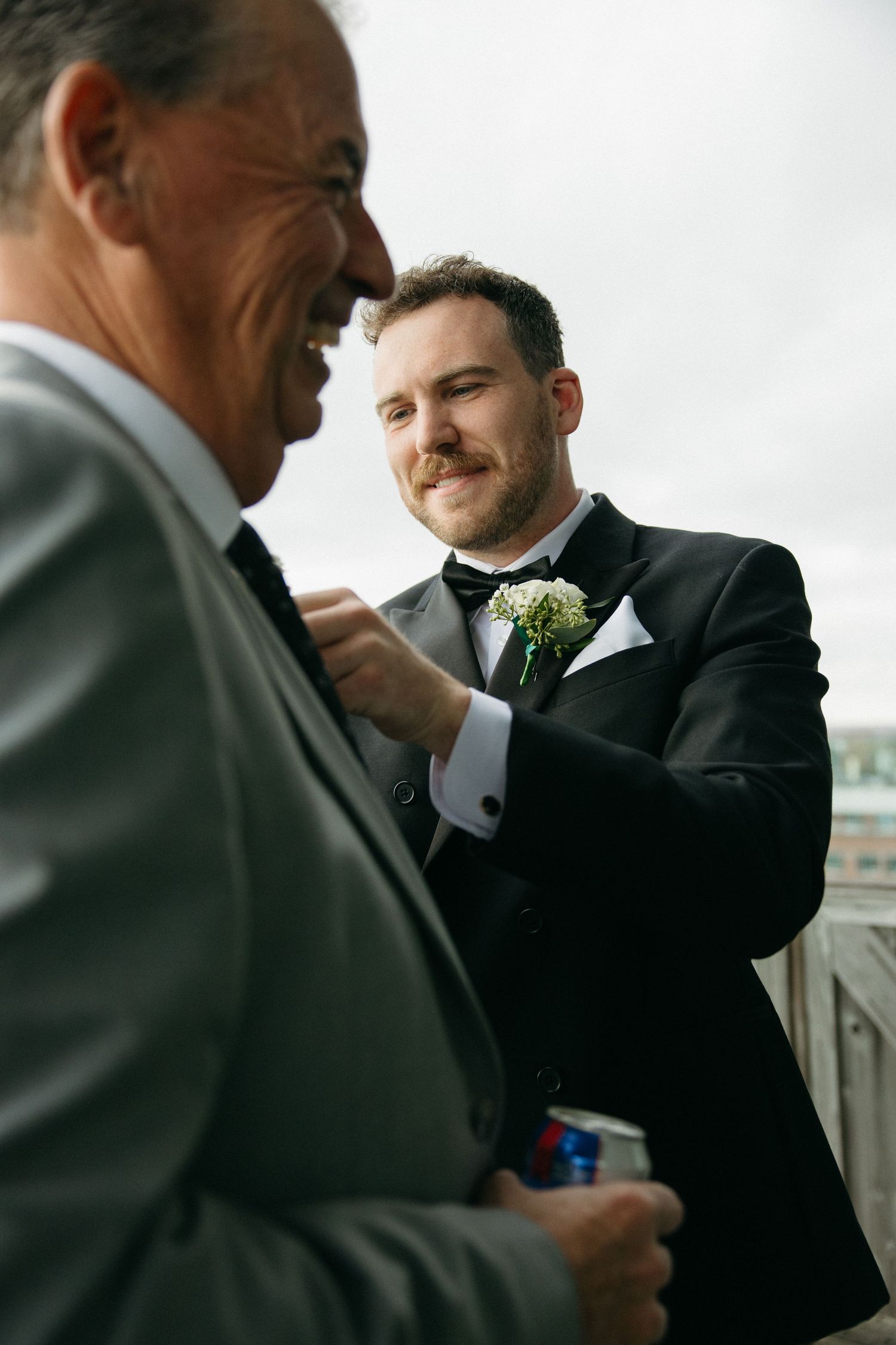A touching moment between family members during a formal celebration.