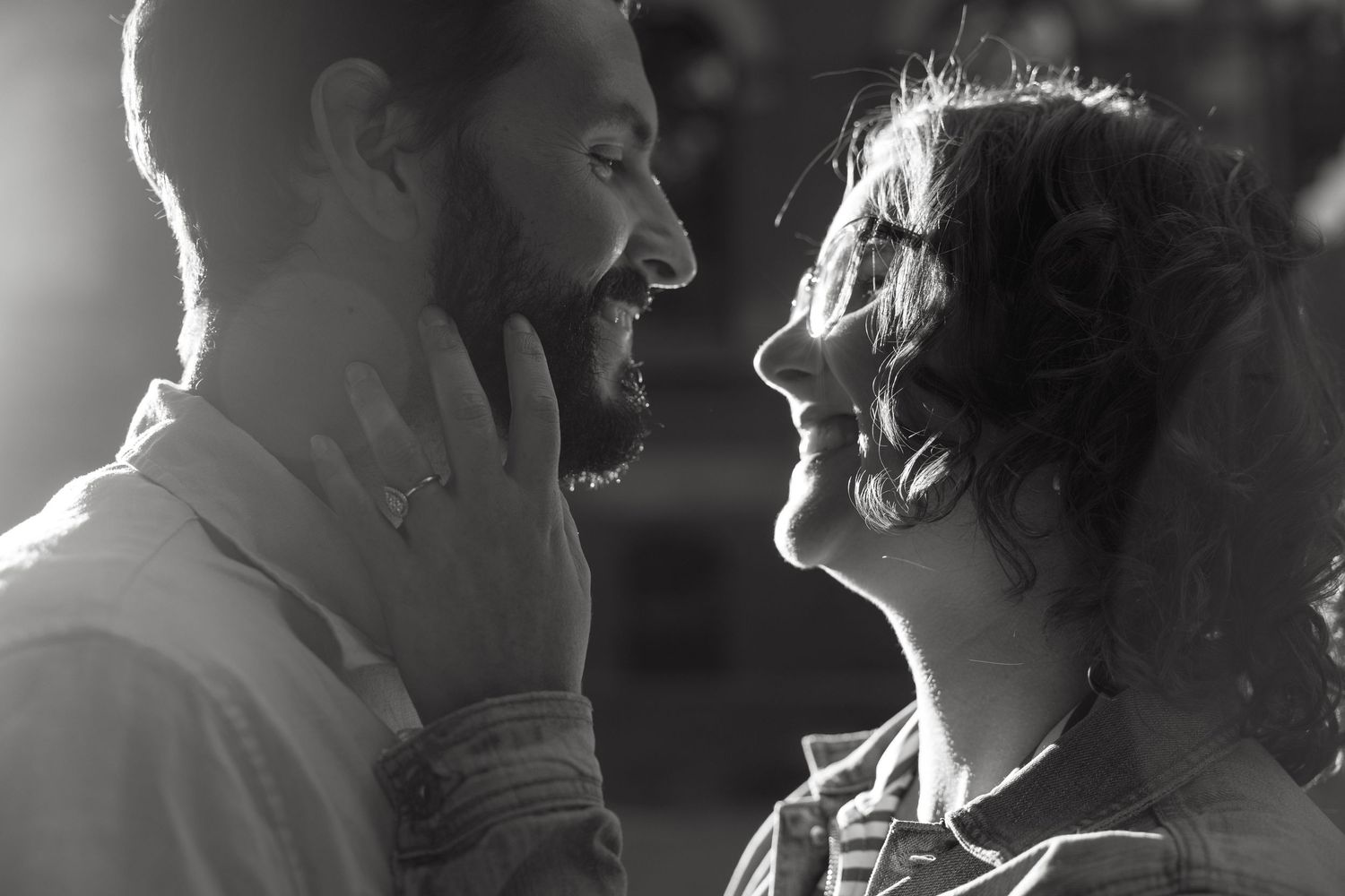 Two people share laughter and intimate moments in a series of black and white photos.