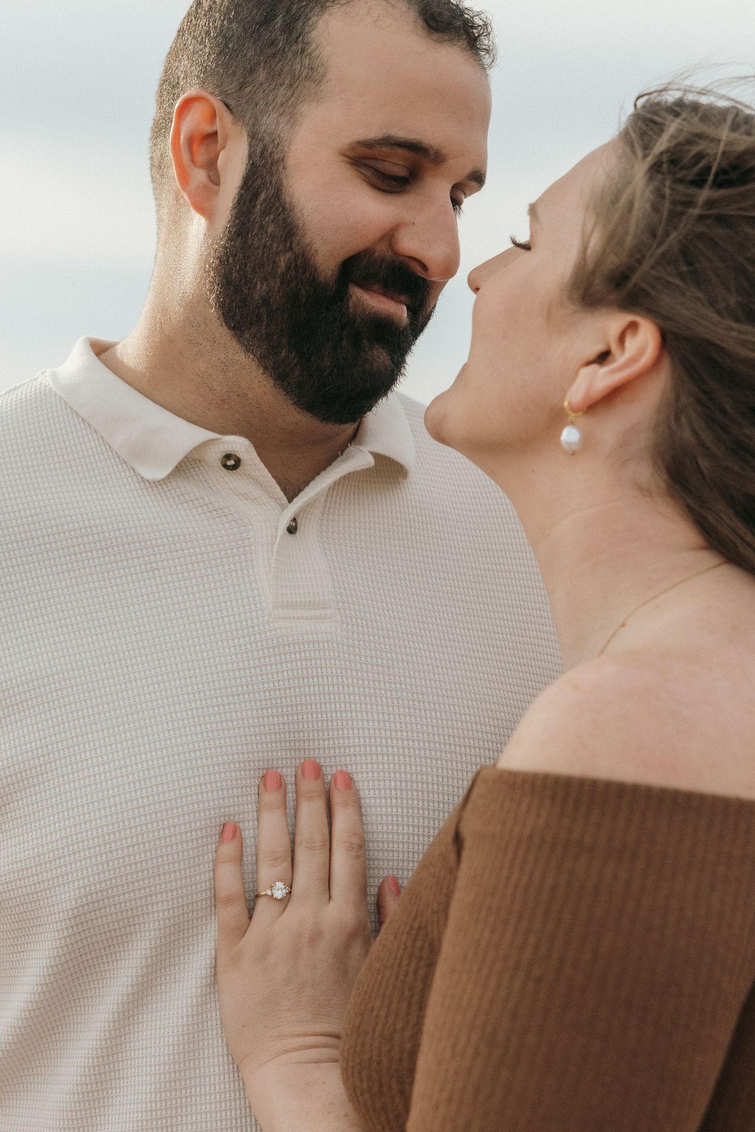 Close-up of a couple sharing an intimate moment on the beach.