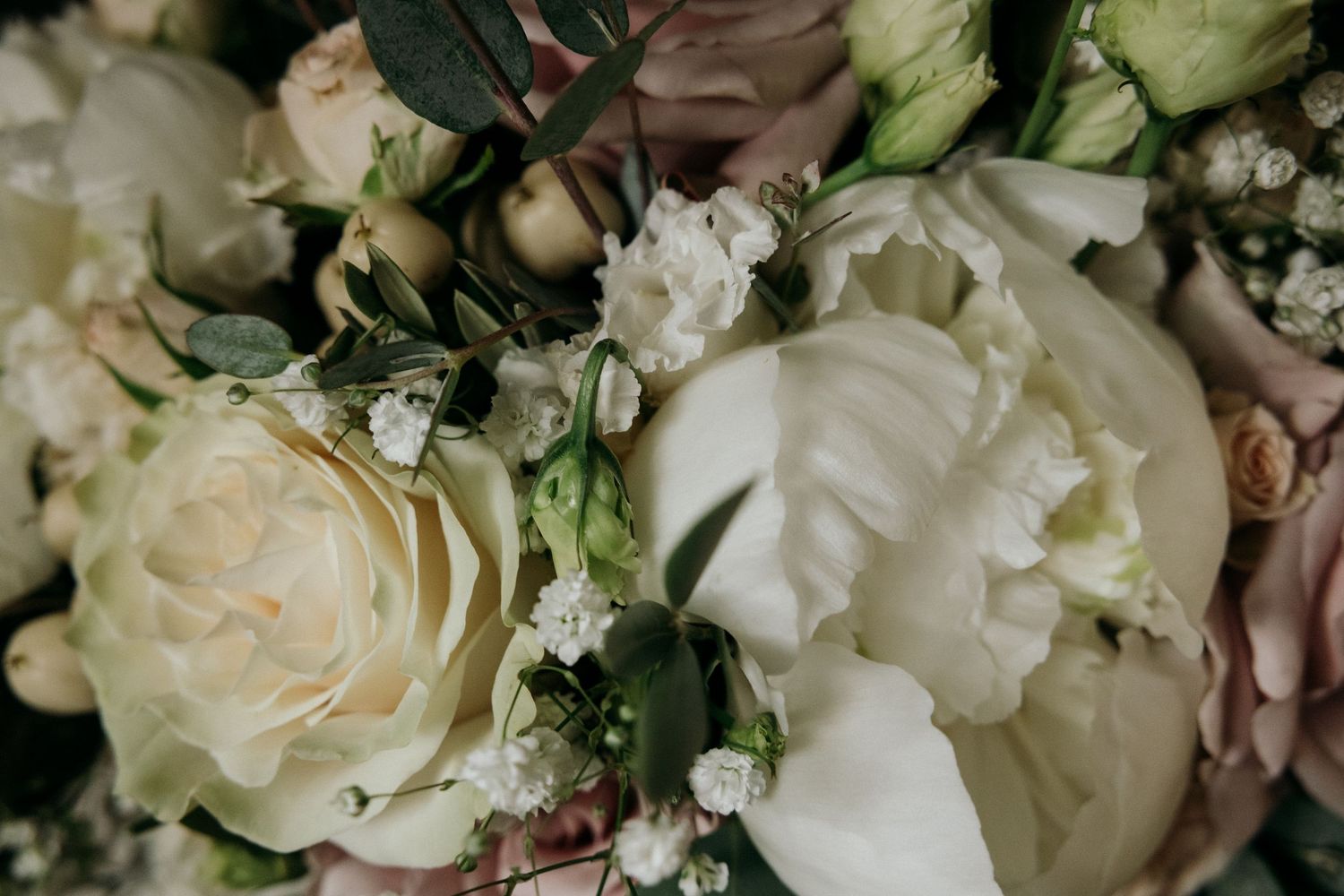 Delicate white roses and floral arrangements with soft green accents.