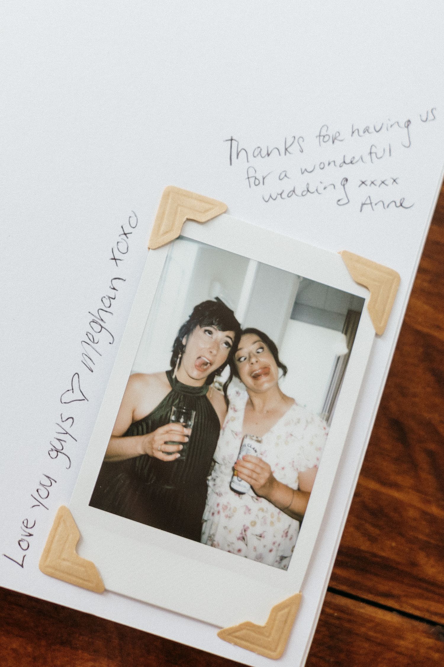 Vintage-style polaroid photos with handwritten notes from wedding guests.